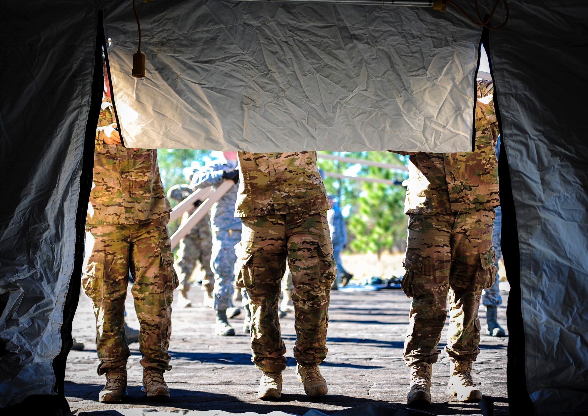 Explosive Ordnance Disposal Airmen with the 1st Special Operations Civil Engineering Squadron, help set up a temporary living unit during exercise Frigid Archer at Eglin Range, Fla., Jan. 6, 2016. Basic fundamentals of J-team were recently tested and trained when an Air Rapid Response Kit (ARRK) was deployed during exercise Frigid Archer, to demonstrate the distinctive capabilities of what the personnel and equipment can accomplish. (U.S. Air Force photo by Senior Airman Meagan Schutter)