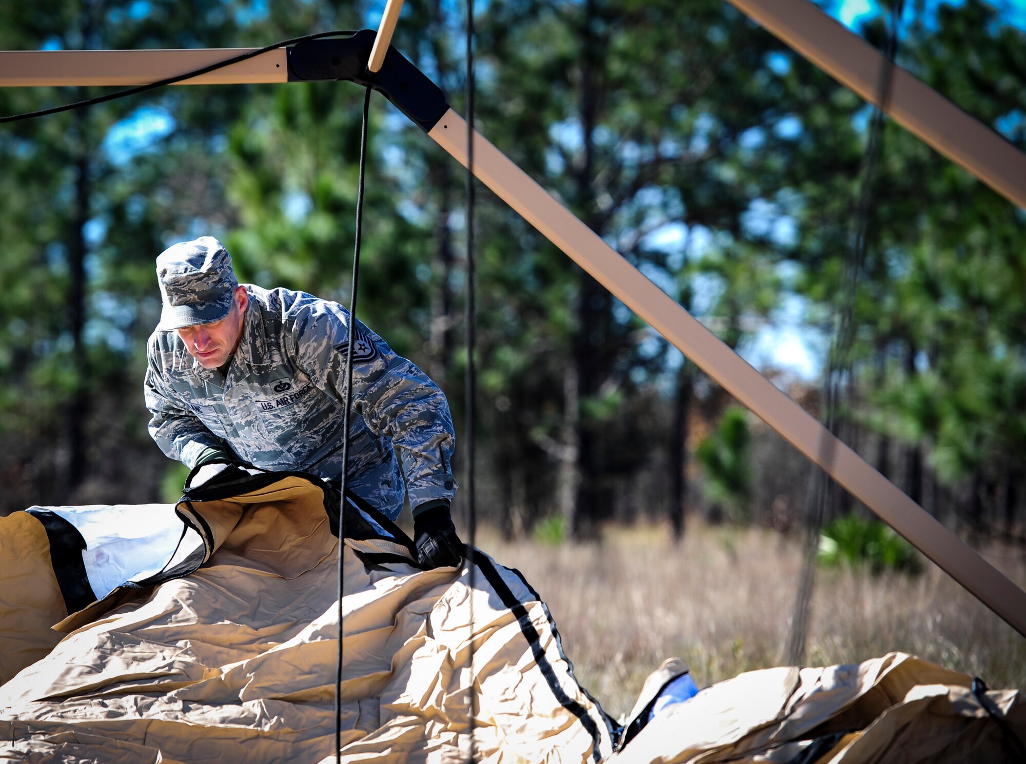 Tech. Sgt. Jason LeBlanc, the maintenance operations supervisor of power production with the 1st Special Operations Civil Engineering Squadron, aligns material for a temporary living unit during exercise Frigid Archer at Eglin Range, Fla., Jan. 6, 2016. Basic fundamentals of J-team were recently tested and trained when an Air Rapid Response Kit (ARRK) was deployed during exercise Frigid Archer, to demonstrate the distinctive capabilities of what the personnel and equipment can accomplish. (U.S. Air Force photo by Senior Airman Meagan Schutter)