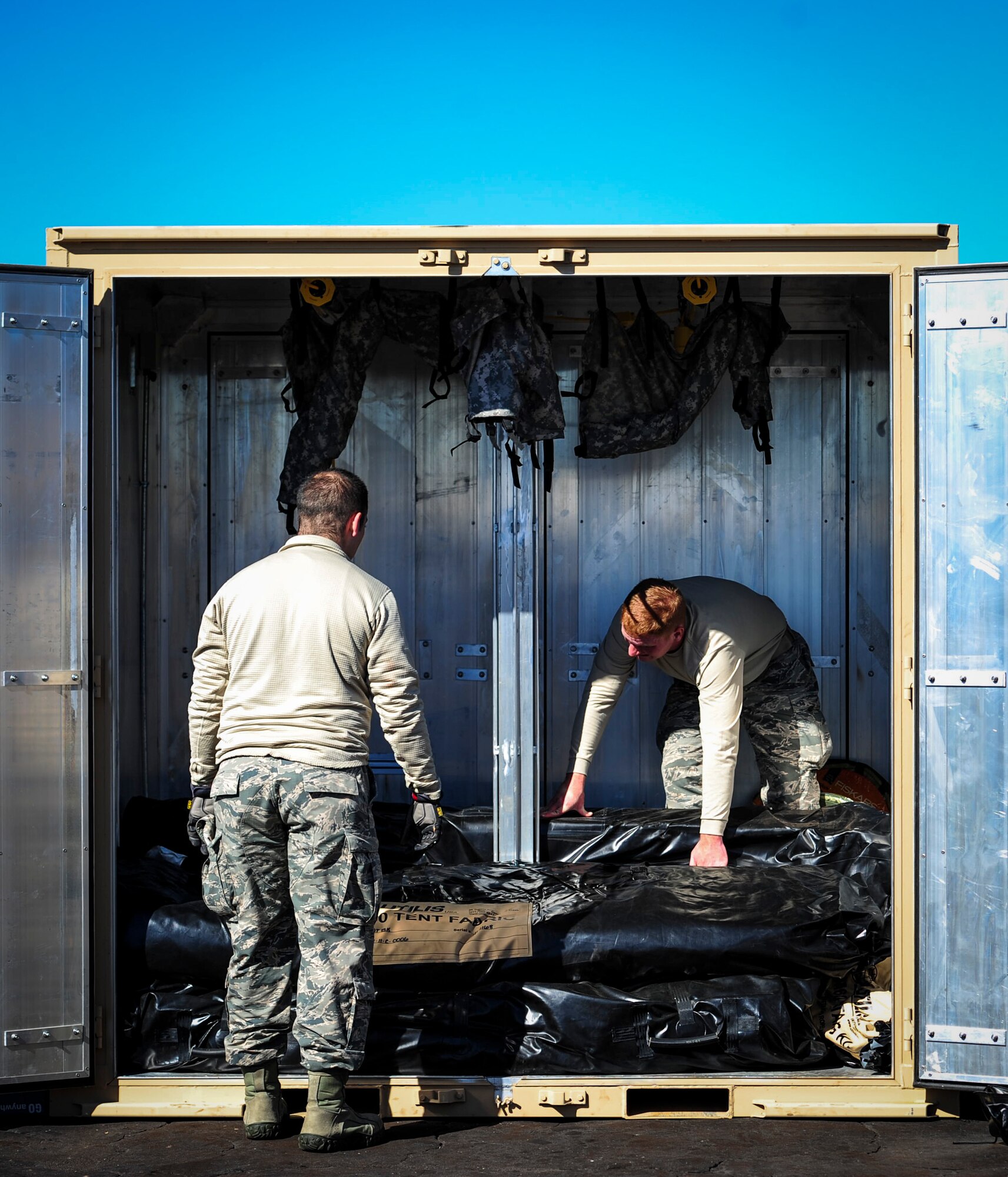 Airmen with the 1st Special Operations Civil Engineering Squadron, unload temporary living unit kits during exercise Frigid Archer at Eglin Range, Fla., Jan. 6, 2016. There was a total of 250 Airmen participating in the exercise. Sixty Airmen came from the 1st SOCES. (U.S. Air Force photo by Senior Airman Meagan Schutter)