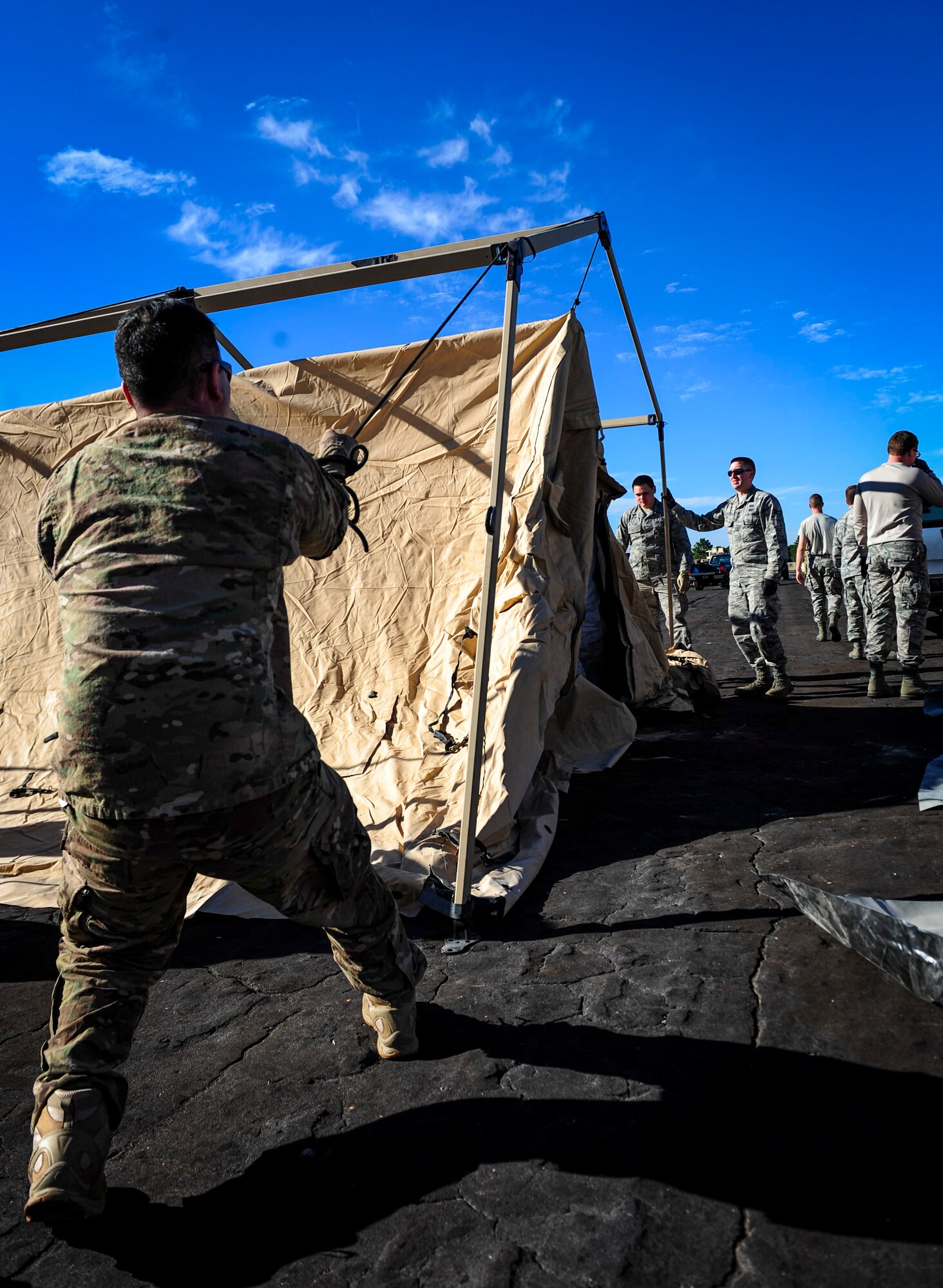 Airman 1st Class Charles De Guia, an Explosive Ordnance Disposal journeyman with the 1st Special Operations Civil Engineering Squadron, helps assemble a temporary living during exercise Frigid Archer at Eglin Range, Fla., Jan. 6, 2016. There was a total of 250 Airmen participating in the exercise. Sixty Airmen came from the 1st SOCES. (U.S. Air Force photo by Senior Airman Meagan Schutter)
