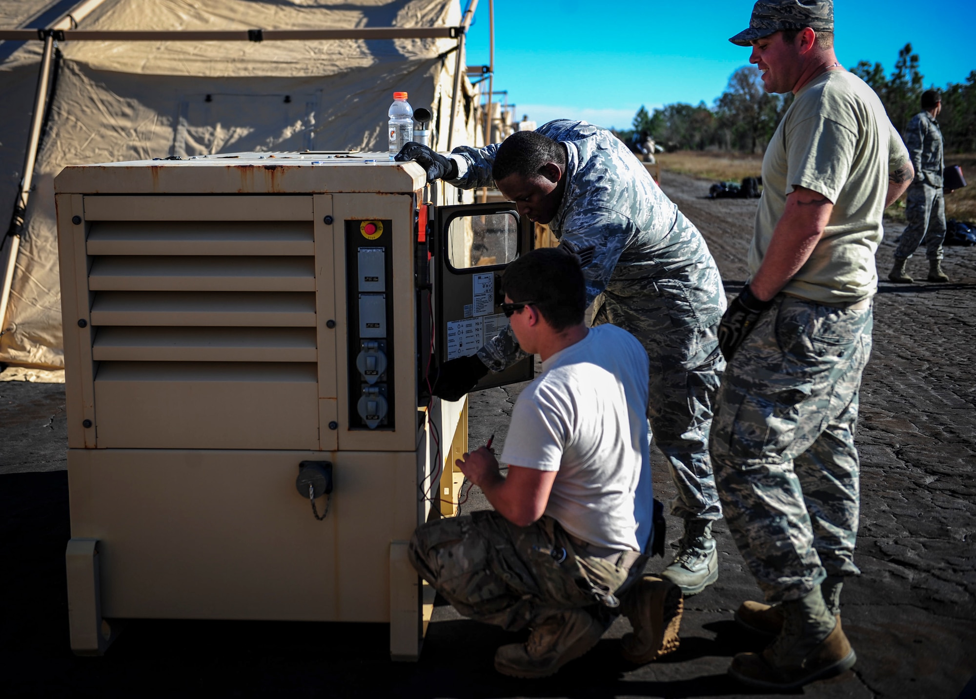 Electricians with the 1st Special Operations Civil Engineering Squadron, test the voltage on generators during exercise Frigid Archer at Eglin Range, Fla., Jan. 6, 2016. There was a total of 250 Airmen participating in the exercise. Sixty Airmen came from the 1st SOCES. (U.S. Air Force photo by Senior Airman Meagan Schutter)