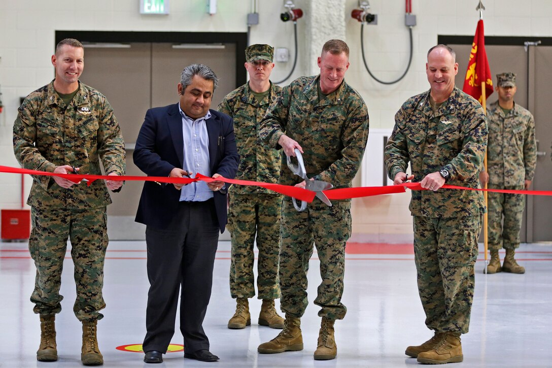 Col. Michael Borqschulte, MAG-39 commanding officer,Sameet Gadi, Balfour Beatty senior vice president, Brig. Gen. Edward D. Banta, MCI-West Commanding Genera and Col. Ian R. Clark, Marine Corps Air Station Camp Pendleton commanding officer, cut a ribbon to unveil hangar six in MCAS Camp Pendleton, a hangar uniquely designed with the purpose of storing and maintaining MV-22 Ospreys. (U.S. Marine Corps photo by Cpl. Shaltiel Dominguez/ Released)