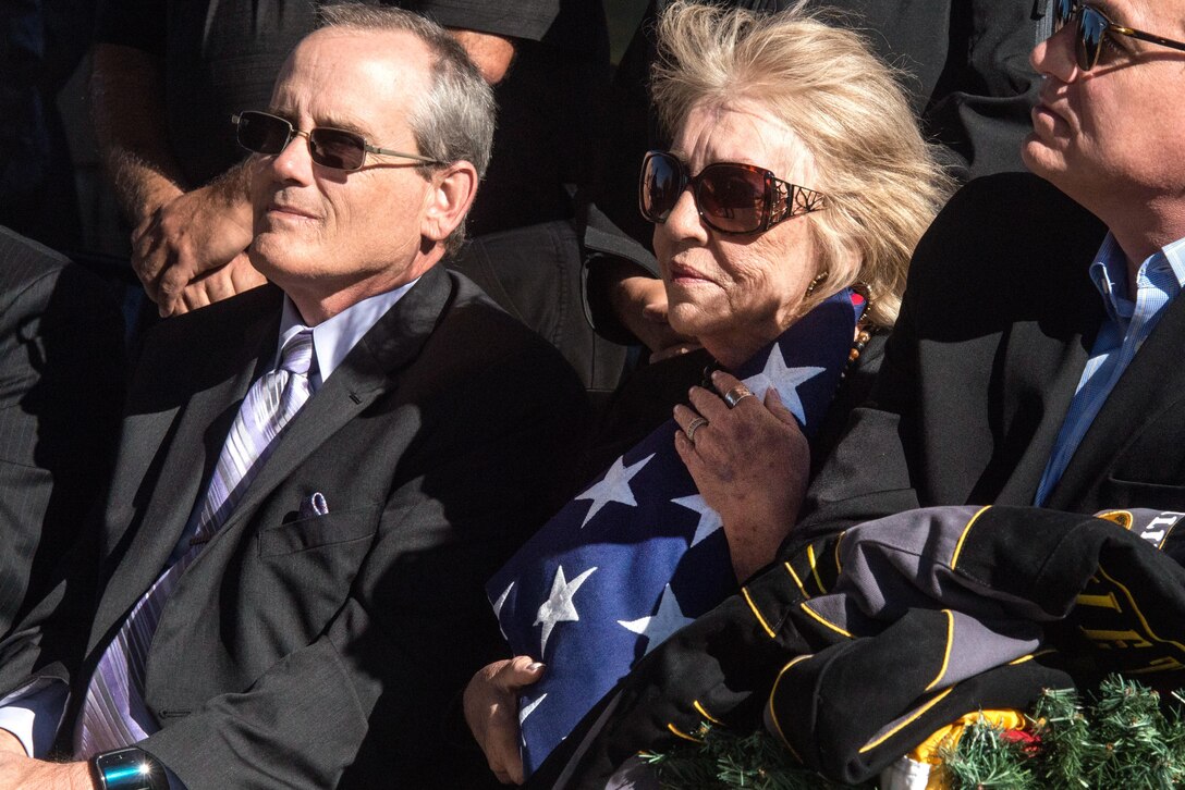 Ms. Beveryly Jacobs, clutches the flag of Sgt. 1st Class Billy David Hill during his full military honors funeral, Killeen, Texas, Dec. 18, 2015. Sergeant Hill was killed in action during the Vietnam conflict Jan 21, 1968 and his remains were later recovered and identified by the Defense POW/MIA Accounting Agency. (DoD photo by Staff Sgt. Erik Cardenas/U.S. Air Force)