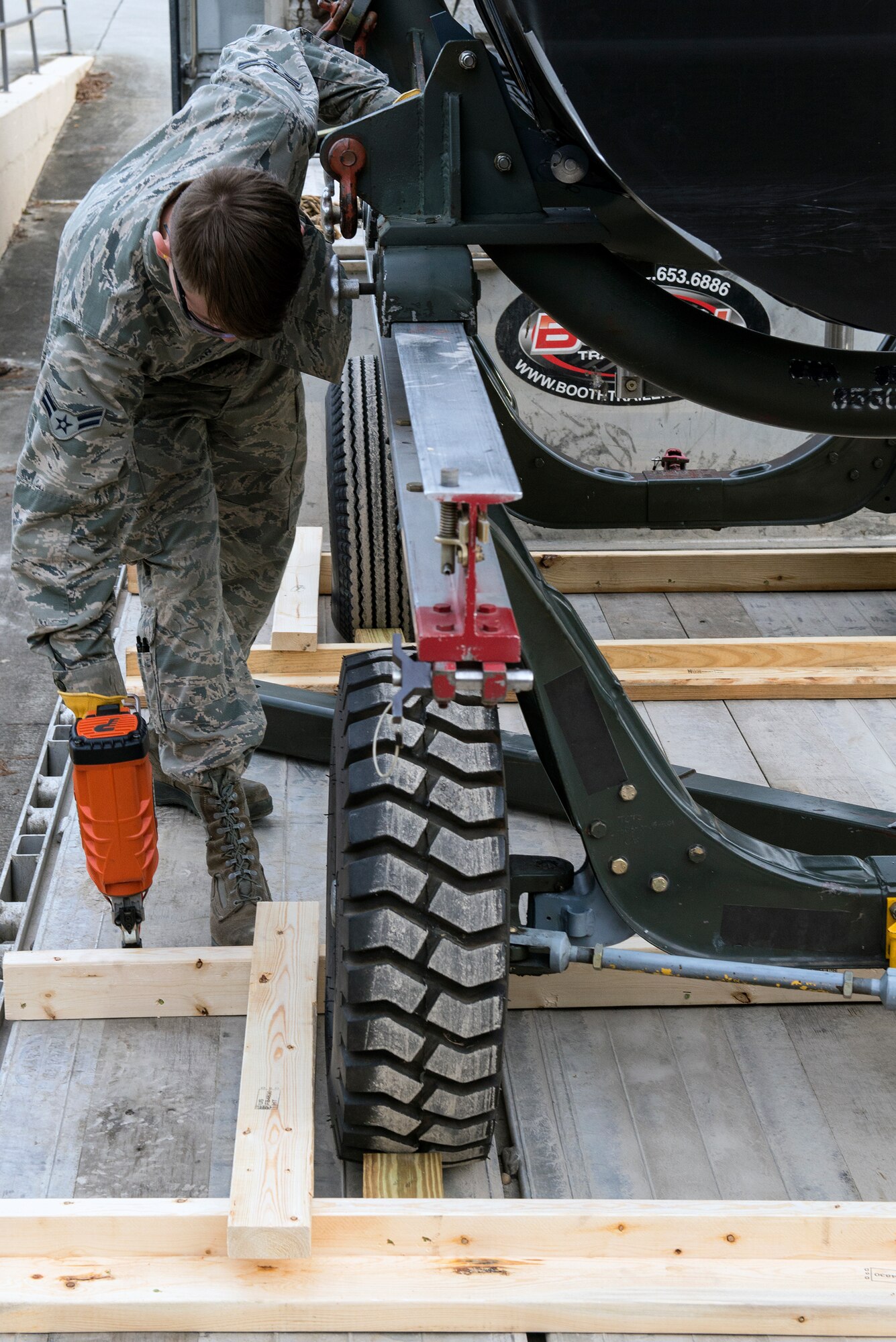 U.S. Air Force Airman 1st Class Thomas Sloan, 23d Logistics Readiness Squadron traffic management flight journeyman, uses a power gun to secure wooden barriers around a TF-34 engine, Jan. 14, 2016, at Moody Air Force Base, Ga. After safely loading the engine, it will be transported to Joint Base McGuire-Dix-Lakehurst, AFB, N.J., to be airlifted overseas to support A-10C Thunderbolt II pilots from the 74th Fighter Squadron. (U.S. Air Force photo by Airman 1st Class Greg Nash/Released)