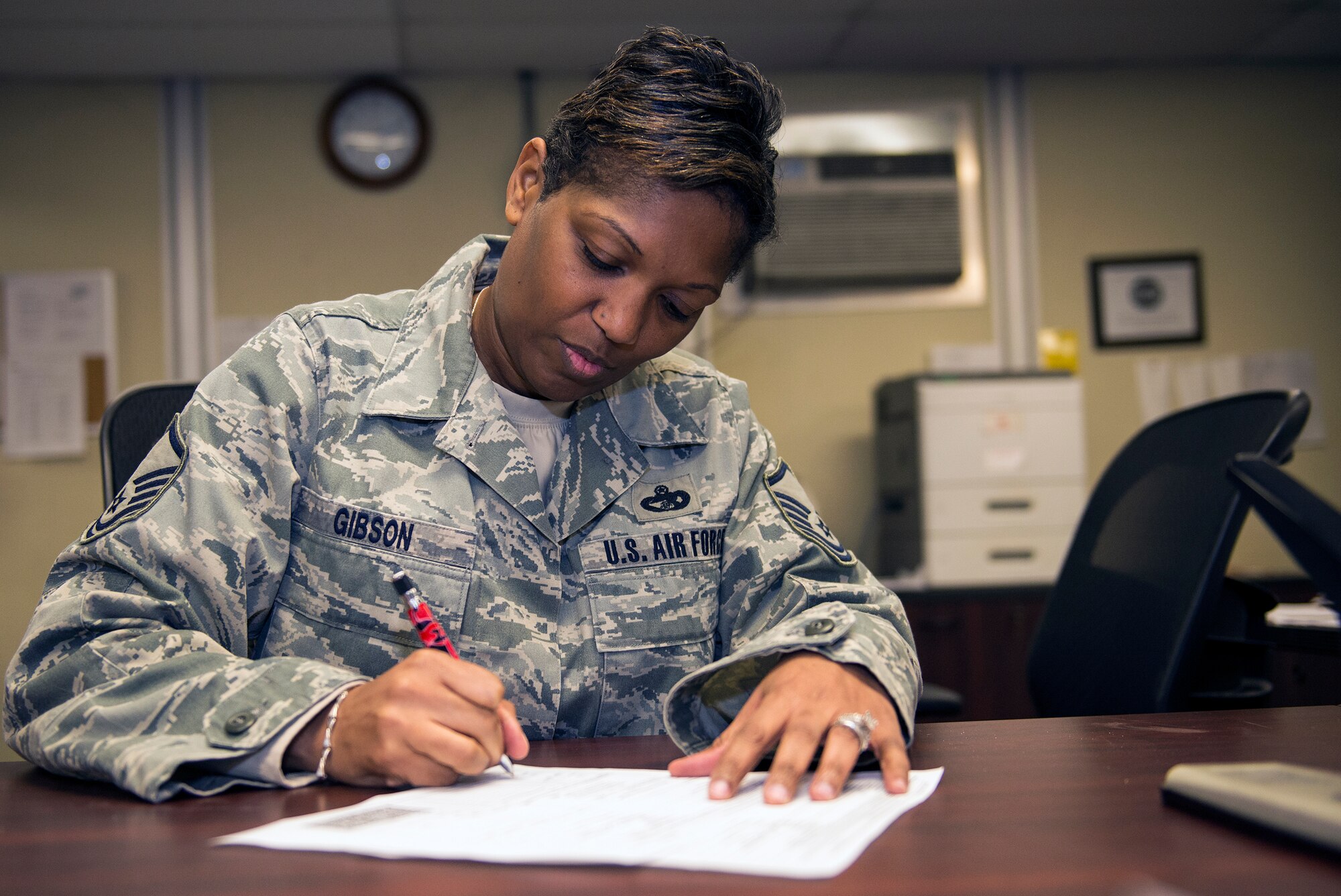 U.S. Air Force Master Sgt. Kimberly Gibson, 23d Logistics Readiness Squadron traffic management flight superintendent, signs an invoice after receiving a TF-34 engine, Jan. 14, 2016, at Moody Air Force Base, Ga.  The form is a requisition, invoice and shipping document which enables the traffic management flight to find transportation for the engine with a ground carrier to be delivered to its destination. (U.S. Air Force photo by Airman 1st Class Greg Nash/Released)