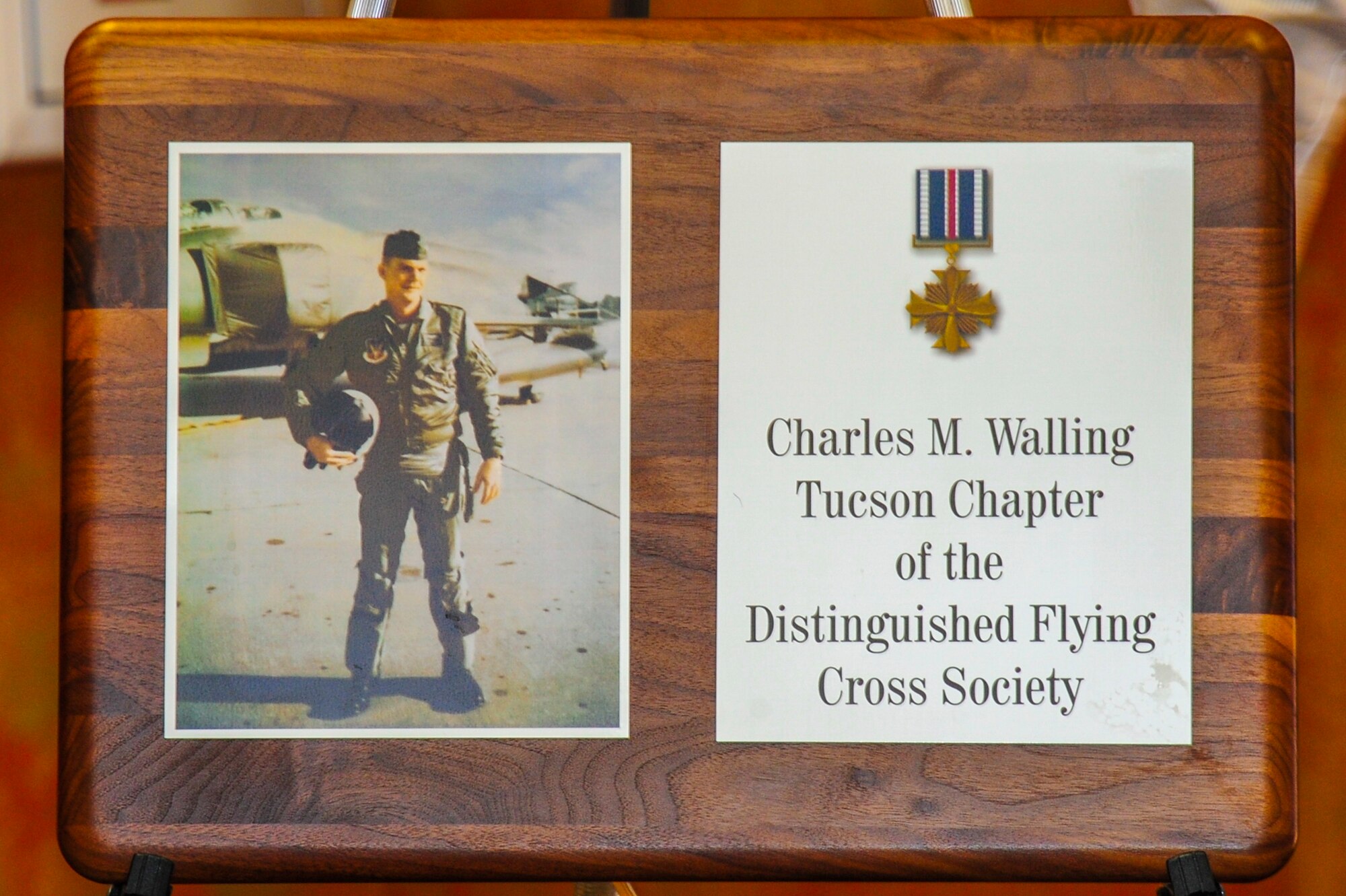 A plaque with a picture of U.S. Air Force Lt. Col. Charles M. Walling and the new name of the Tucson Chapter of the Distinguished Flying Cross Society was unveiled at Davis-Monthan Air Force Base, Ariz., Jan. 13, 2016. Walling died while flying an F4C Phantom that crashed during a close air support mission over Song Be Province, Vietnam, Aug. 8, 2006.  (U.S. Air Force Photo by Senior Airman Chris Massey/Released)