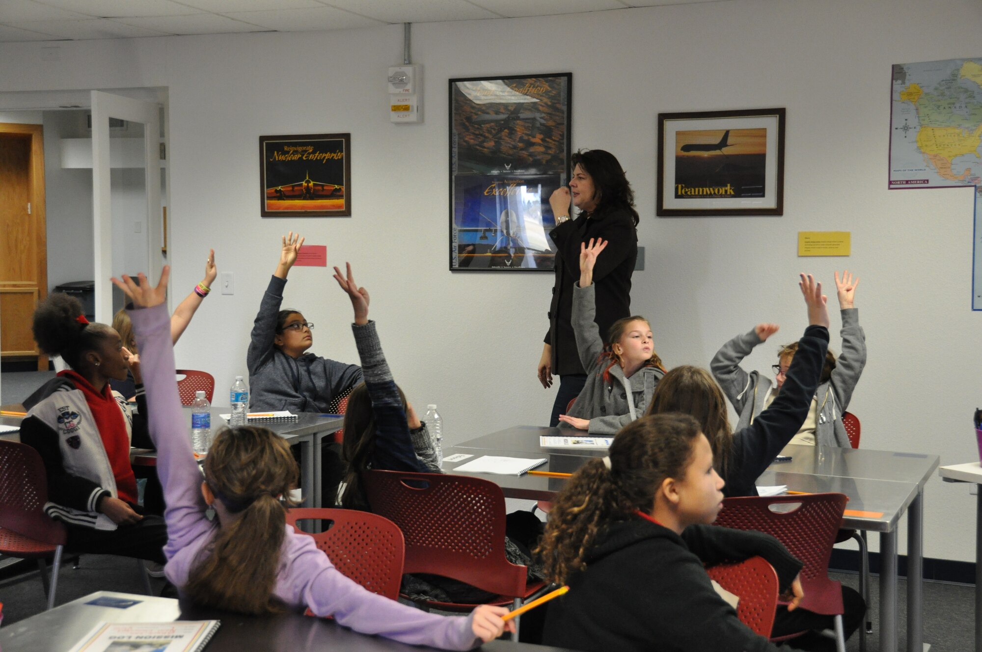 NELLIS AIR FORCE BASE, Nev. -- STARBASE NELLIS teacher, Estela Nencescue, administers an end-of-class quiz to students from Neal Elementary School here Jan. 8 to assess how much they learned from the day's lesson. STARBASE is a Department of Defense educational program, sponsored by the Office of the Assistant Secretary of Defense for Reserve Affairs where students participate in science, technology, engineering and math activities. Students are immersed in a unique classroom experience for five days where all activities are student-centered, hands-on, encourage higher-order thinking and incorporate STEM applications in the real world. (Information collected from dodstarbase.org.) (U.S. Air Force photo/Maj. Jessica D'Ambrosio)