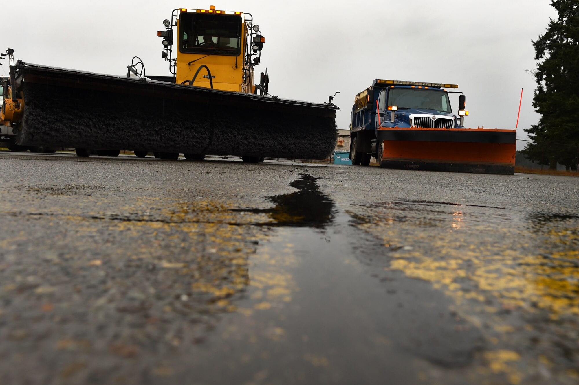 Heavy equipment vehicles used by the 627th Civil Engineer Squadron pavement and heavy equipment flight sit in the parking lot near the McChord Field flight line at Joint Base Lewis-McChord, Wash., Jan. 12, 2016. The pavement and heavy equipment flight ensures the flight line is in good working order and they repair it if necessary. They are also responsible for snow and ice control on the McChord Field flight line and the road ways of Joint Base Lewis-McChord. (U.S. Air Force photo/Senior Airman Naomi Shipley)