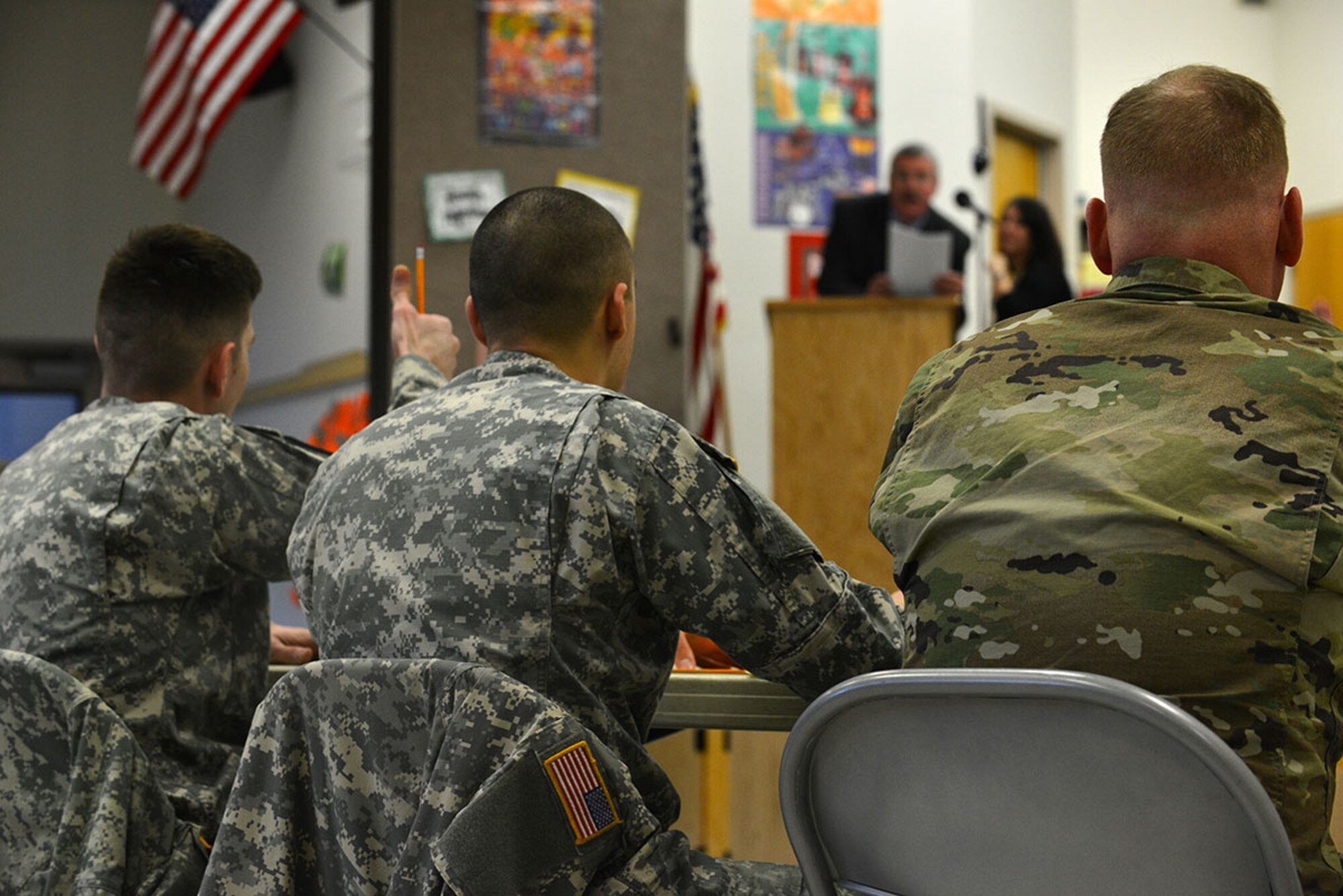 U.S. Army Sgt. Andrew Csog a squad leader with the 17th Combat Sustainment Support Battalion (left), 2nd Lt. Kenneth Canali, a platoon leader with the 17th CSSB (center), and  Lt. Col. John Gavin, 17th CSSB commander listen to a student spell Arch as part of Ursa Major's spelling bee Jan. 7 at the school. Volunteers from the 17th CSSB served as judges as part of Joint Base Elmendorf-Richardson’s partnership program with 29 Anchorage School District locations. (U.S. Air Force photo by Airman 1st Class Kyle Johnson/Released)