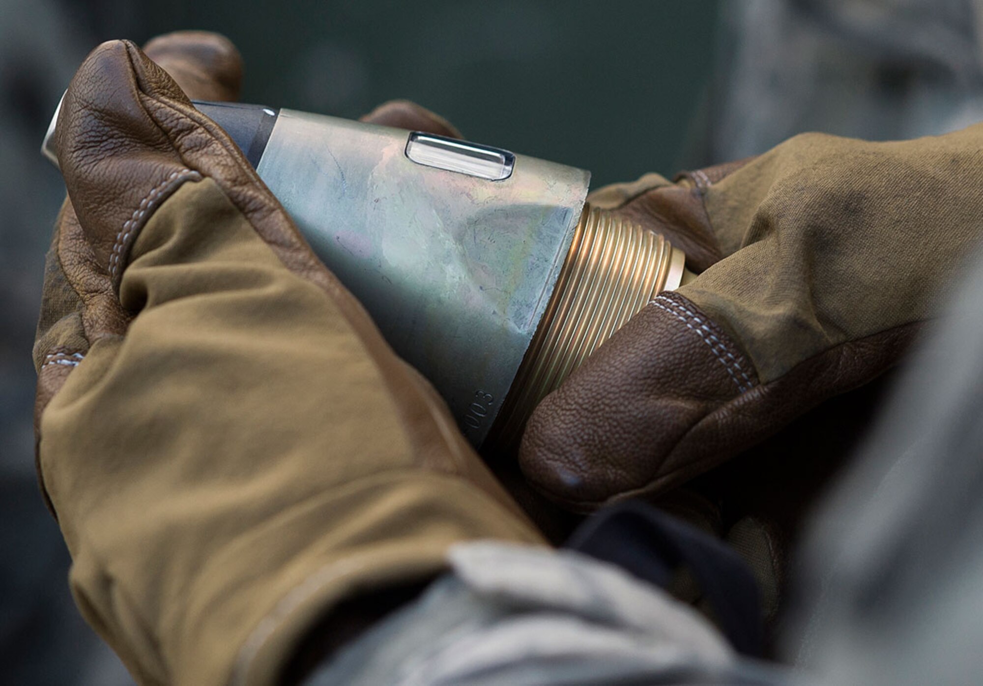 A Soldier assigned to B Battery, 2nd Battalion, 377th Parachute Field Artillery Regiment, 4th Infantry Brigade Combat Team (Airborne), 25th Infantry Division, U.S. Army Alaska, holds the fuze for a 105mm projectile before a live fire with M119A2 105mm howitzers Monday, Jan. 11, 2016. USARAK is home to the Army’s only Pacific airborne brigade combat team, and maintains the only airborne rapid-response capacity within the Pacific Command Area of Responsibility.  (U.S. Air Force photo/Justin Connaher)