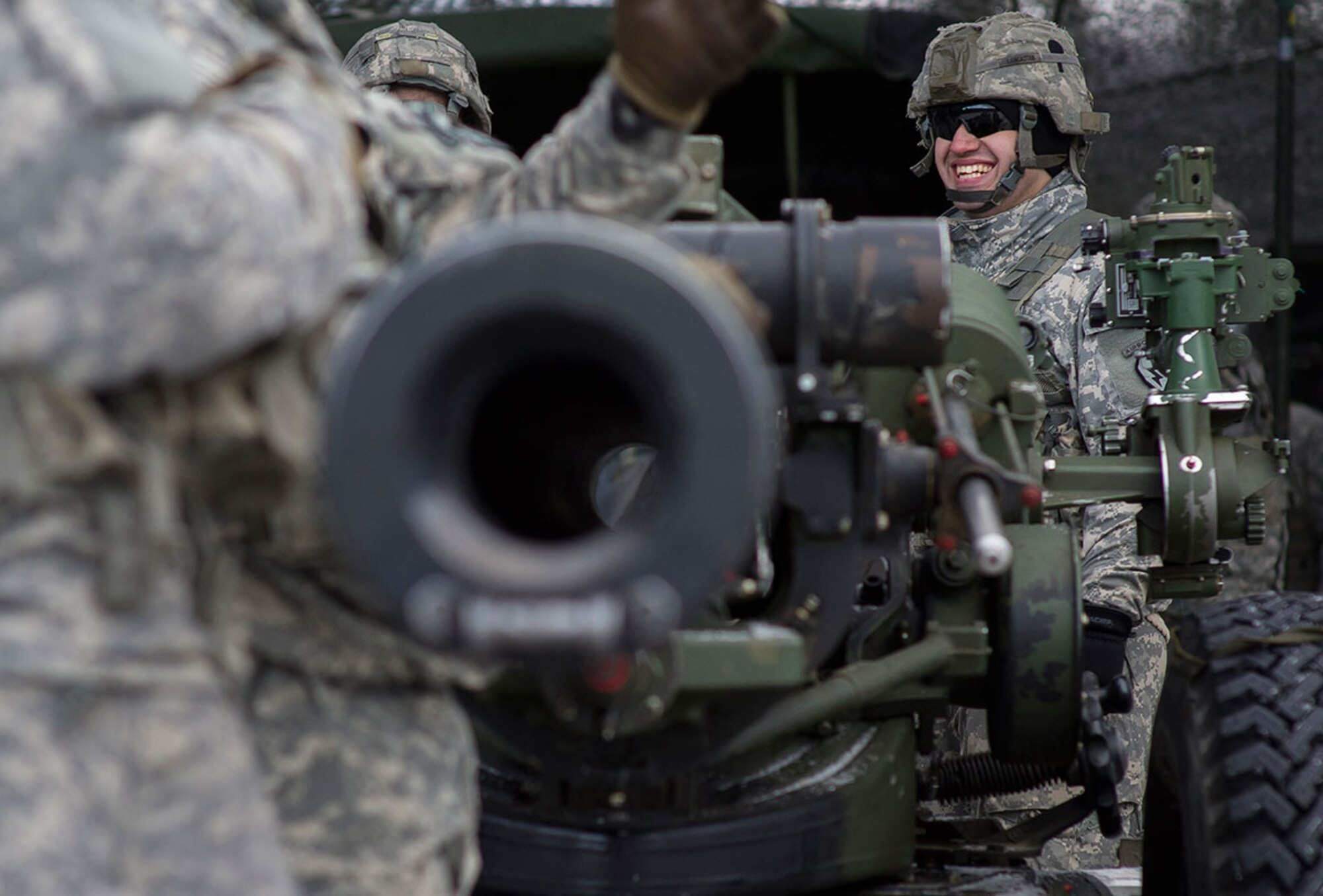 Army Pfc. Michael Lancaster, assigned to B Battery, 2nd Battalion, 377th Parachute Field Artillery Regiment, 4th Infantry Brigade Combat Team (Airborne), 25th Infantry Division, U.S. Army Alaska, laughs with fellow paratroopers before a live fire with M119A2 105mm howitzers, Monday, Jan. 11, 2016. USARAK is home to the Army’s only Pacific airborne brigade combat team, and maintains the only airborne rapid-response capacity within the Pacific Command Area of Responsibility.  (U.S. Air Force photo/Justin Connaher)