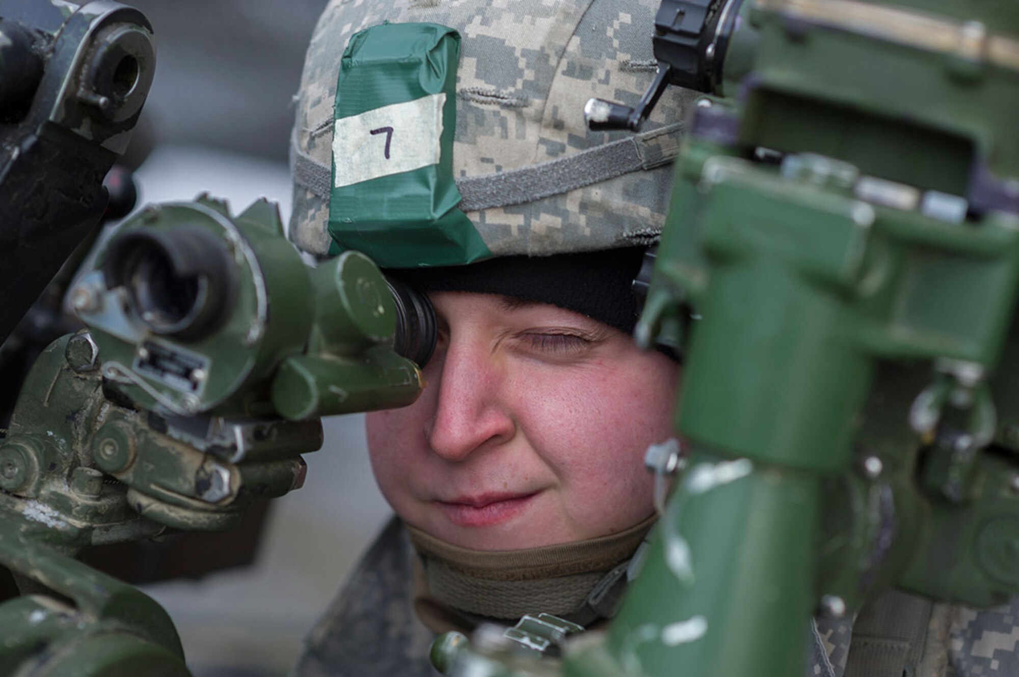 Spc. James Rolf, a native of Oakland, Md., assigned to B Battery, 2nd Battalion, 377th Parachute Field Artillery Regiment, 4th Infantry Brigade Combat Team (Airborne), 25th Infantry Division, U.S. Army Alaska, looks through the direct fire sight of a M119A2 105mm howitzers before a live fire, Monday, Jan. 11, 2016. USARAK is home to the Army’s only Pacific airborne brigade combat team, and maintains the only airborne rapid-response capacity within the Pacific Command Area of Responsibility.  (U.S. Air Force photo/Justin Connaher)