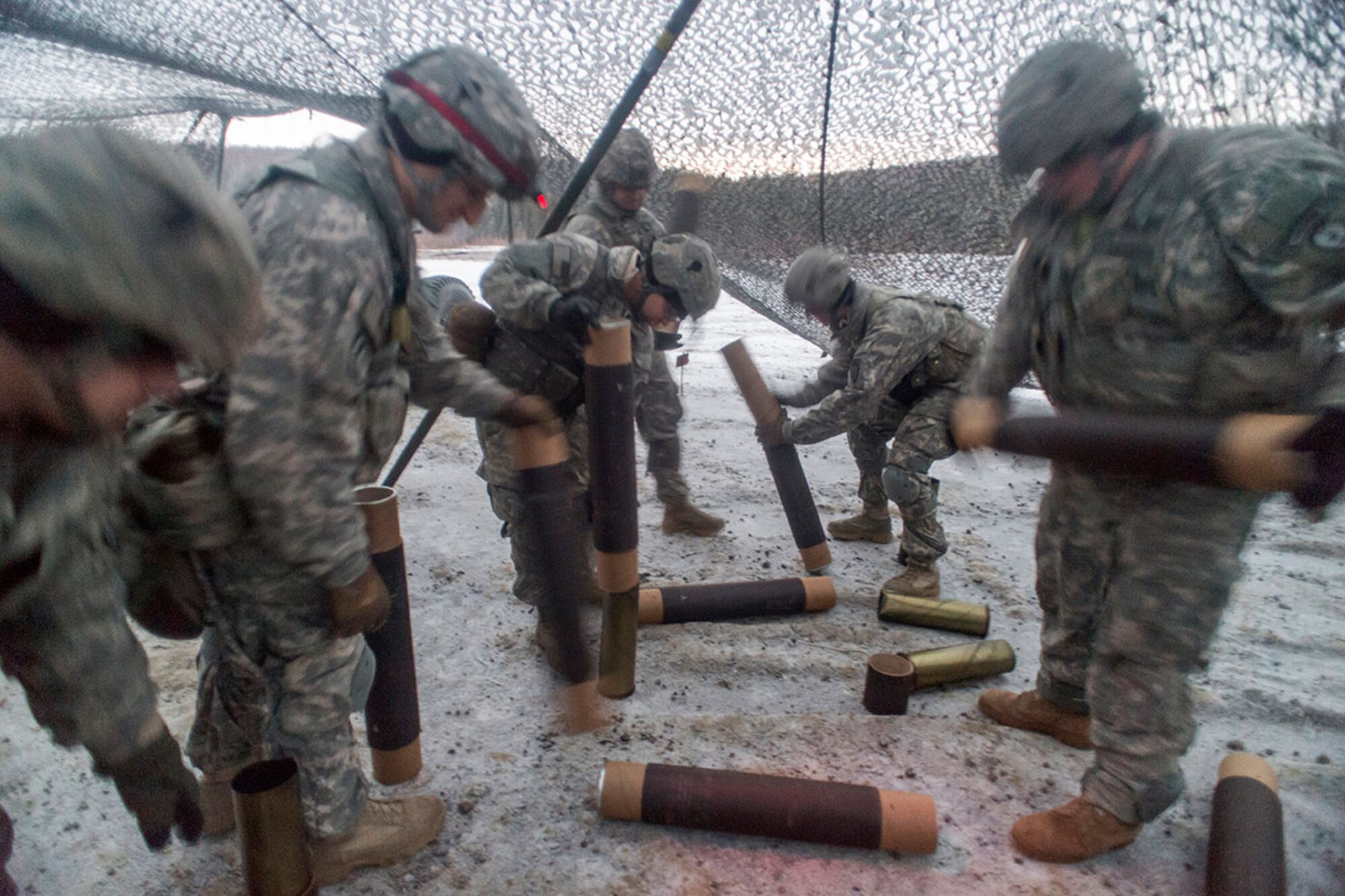 Soldiers assigned to B Battery, 2nd Battalion, 377th Parachute Field Artillery Regiment, 4th Infantry Brigade Combat Team (Airborne), 25th Infantry Division, U.S. Army Alaska, police up expended shell casings after a live fire with M119A2 105mm howitzers, Monday, Jan. 11, 2016. USARAK is home to the Army’s only Pacific airborne brigade combat team, and maintains the only airborne rapid-response capacity within the Pacific Command Area of Responsibility.  (U.S. Air Force photo/Justin Connaher)