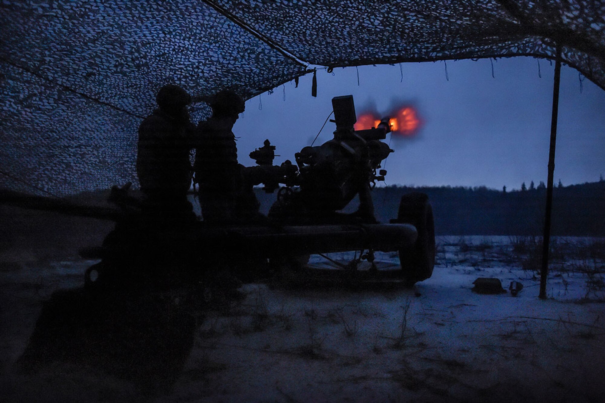 Paratroopers assigned to B Battery, 2nd Battalion, 377th Parachute Field Artillery Regiment, 4th Infantry Brigade Combat Team (Airborne), 25th Infantry Division, U.S. Army Alaska, fire high-explosive rounds from a M119 105mm howitzer at Joint Base Elmendorf-Richardson, Jan. 11, 2016. USARAK is home to the Army’s only Pacific airborne brigade combat team, and maintains the only airborne rapid-response capacity within the Pacific Command area of responsibility. (U.S. Air Force photo/Alejandro Pena)