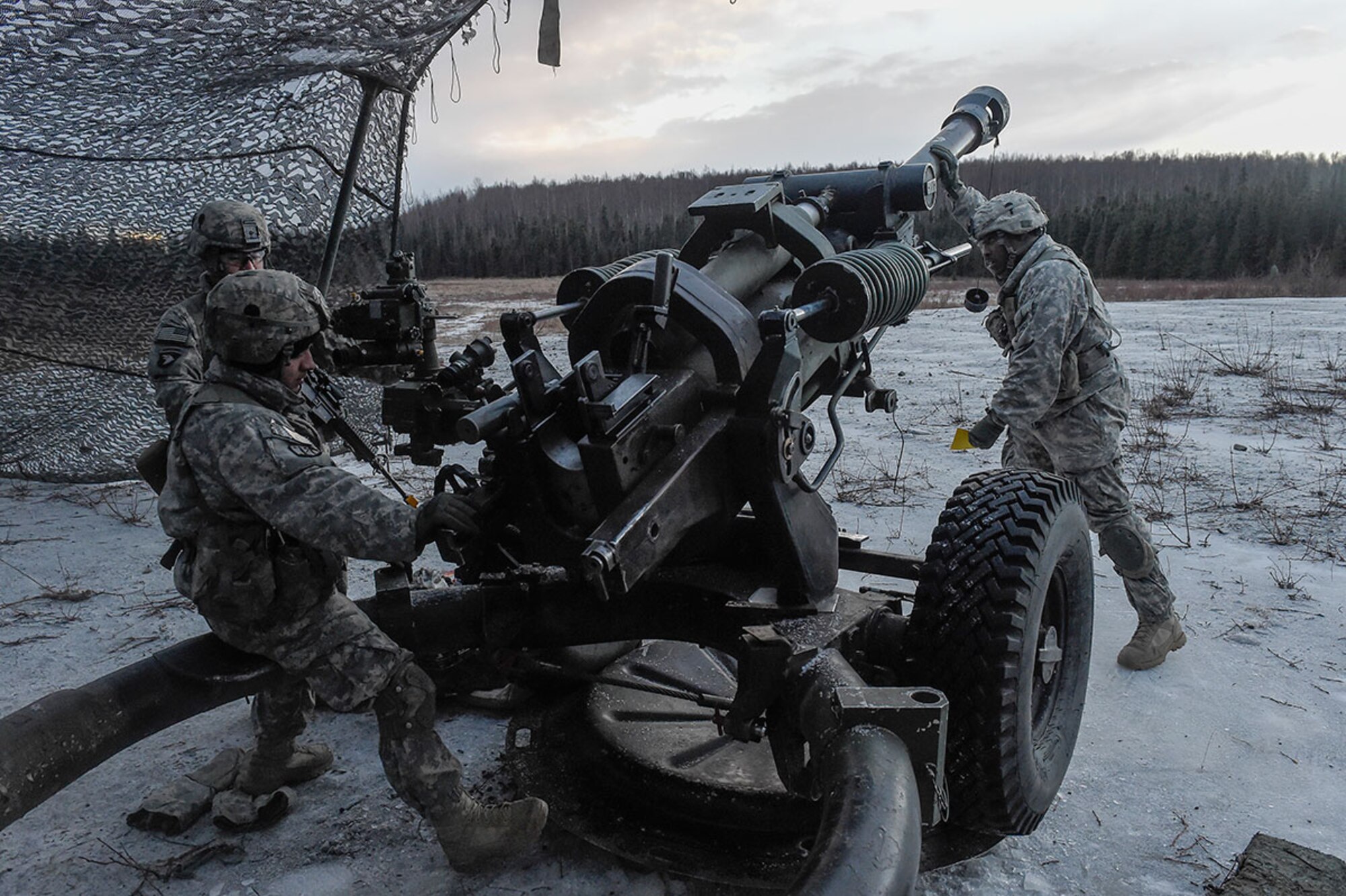 Paratroopers assigned to B Battery, 2nd Battalion, 377th Parachute Field Artillery Regiment, 4th Infantry Brigade Combat Team (Airborne), 25th Infantry Division, U.S. Army Alaska, position a M119 105mm howitzer while conducting live-fire training at Joint Base Elmendorf-Richardson, Jan. 11, 2016. USARAK is home to the Army’s only Pacific airborne brigade combat team, and maintains the only airborne rapid-response capacity within the Pacific Command area of responsibility. (U.S. Air Force photo/Alejandro Pena)