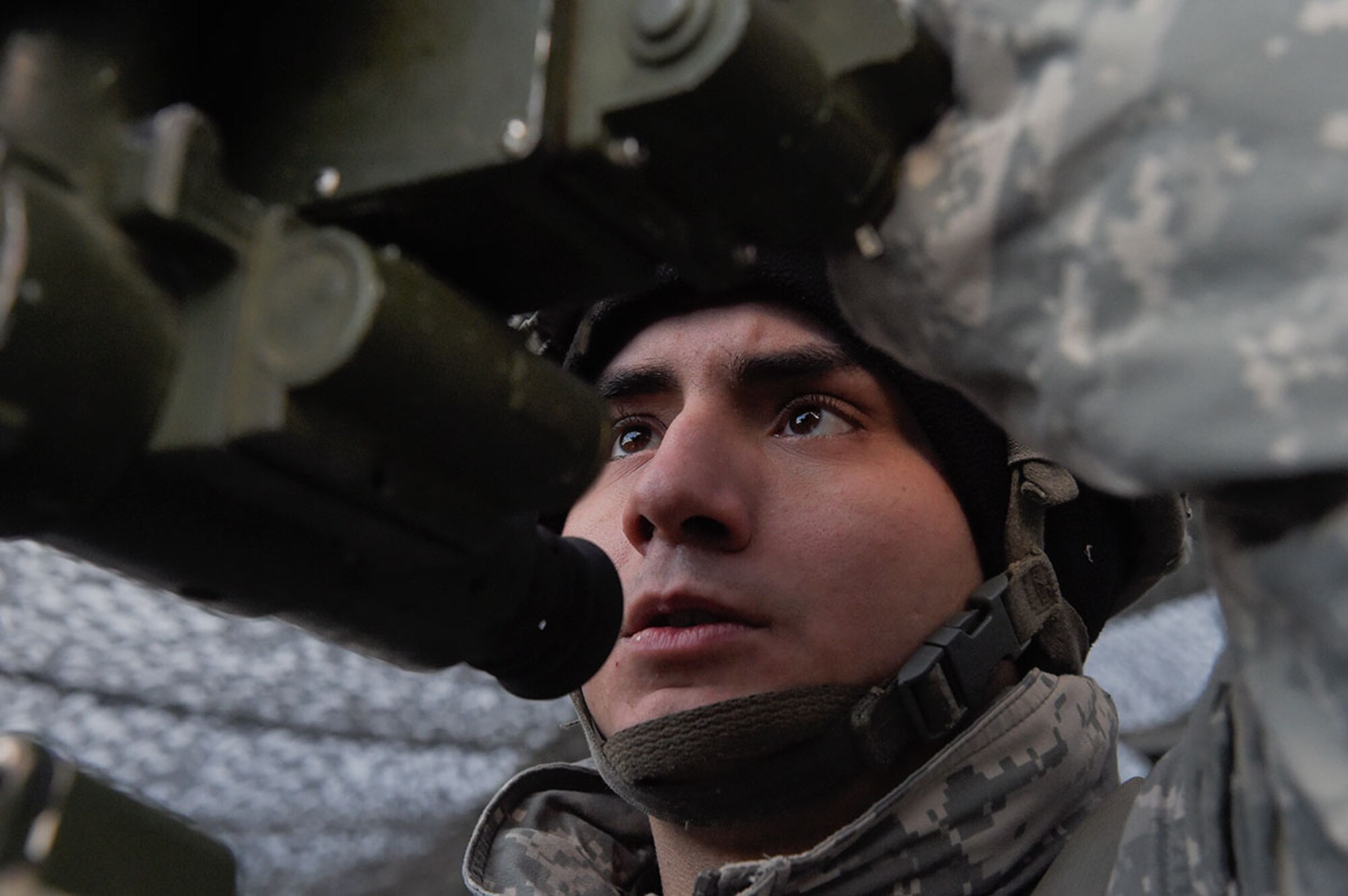 Sgt. Michael Jimenez, a native of Chicago, Ill., assigned to B Battery, 2nd Battalion, 377th Parachute Field Artillery Regiment, 4th Infantry Brigade Combat Team (Airborne), 25th Infantry Division, U.S. Army Alaska, adjusts a M119 105mm howitzer gun sight while conducting live-fire training at Joint Base Elmendorf-Richardson, Jan. 11, 2016. USARAK is home to the Army’s only Pacific airborne brigade combat team, and maintains the only airborne rapid-response capacity within the Pacific Command area of responsibility. (U.S. Air Force photo/Alejandro Pena)