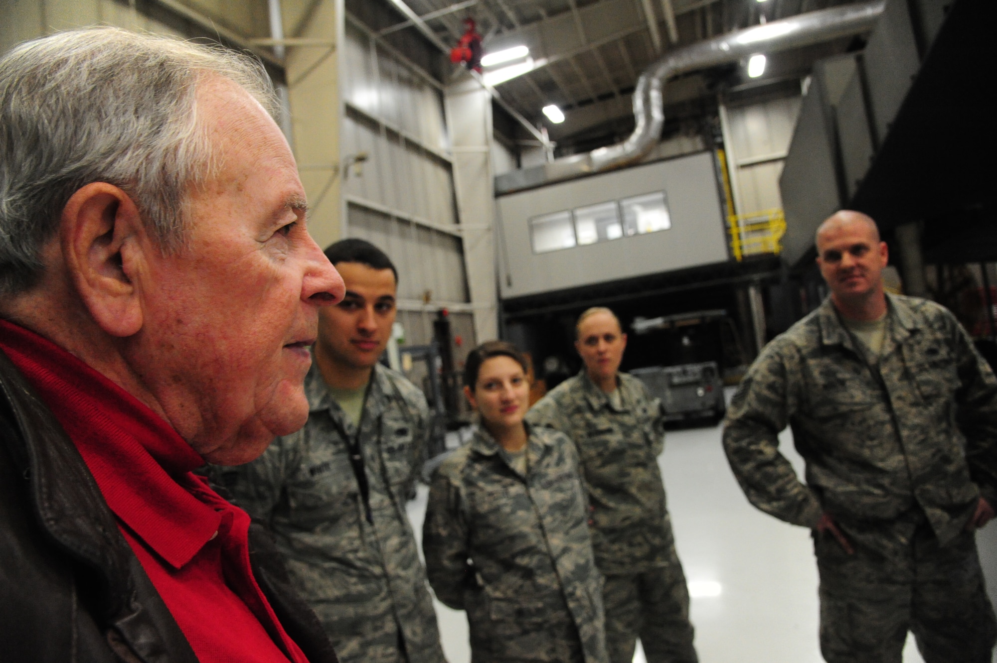 Charlie Brown, the 13th Bomb Squadron Association president, talks to Airmen from the 13th Aircraft Maintenance Unit at Whiteman Air Force Base, Mo., Dec. 17, 2015. The Airmen were educated on how maintenance operations were performed in the past by the veterans as well as about the association’s mission. (U.S. Air Force photo by Senior Airman Keenan Berry)
