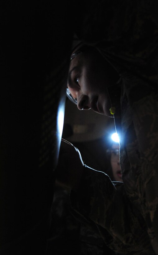 U.S. Air Force Staff Sgt. Joshua Rozman, a 393rd Aircraft Maintenance Unit load crew member secures a GBU-28 B/B into a B-2 Spirit weapons load trainer at Whiteman Air Force Base, Mo., Jan 13, 2016. The competition is judged on several aspects to include timeliness and technical deficiencies during the weapons load evaluation. (U.S. Air Force photo by Senior Airman Joel Pfiester)
