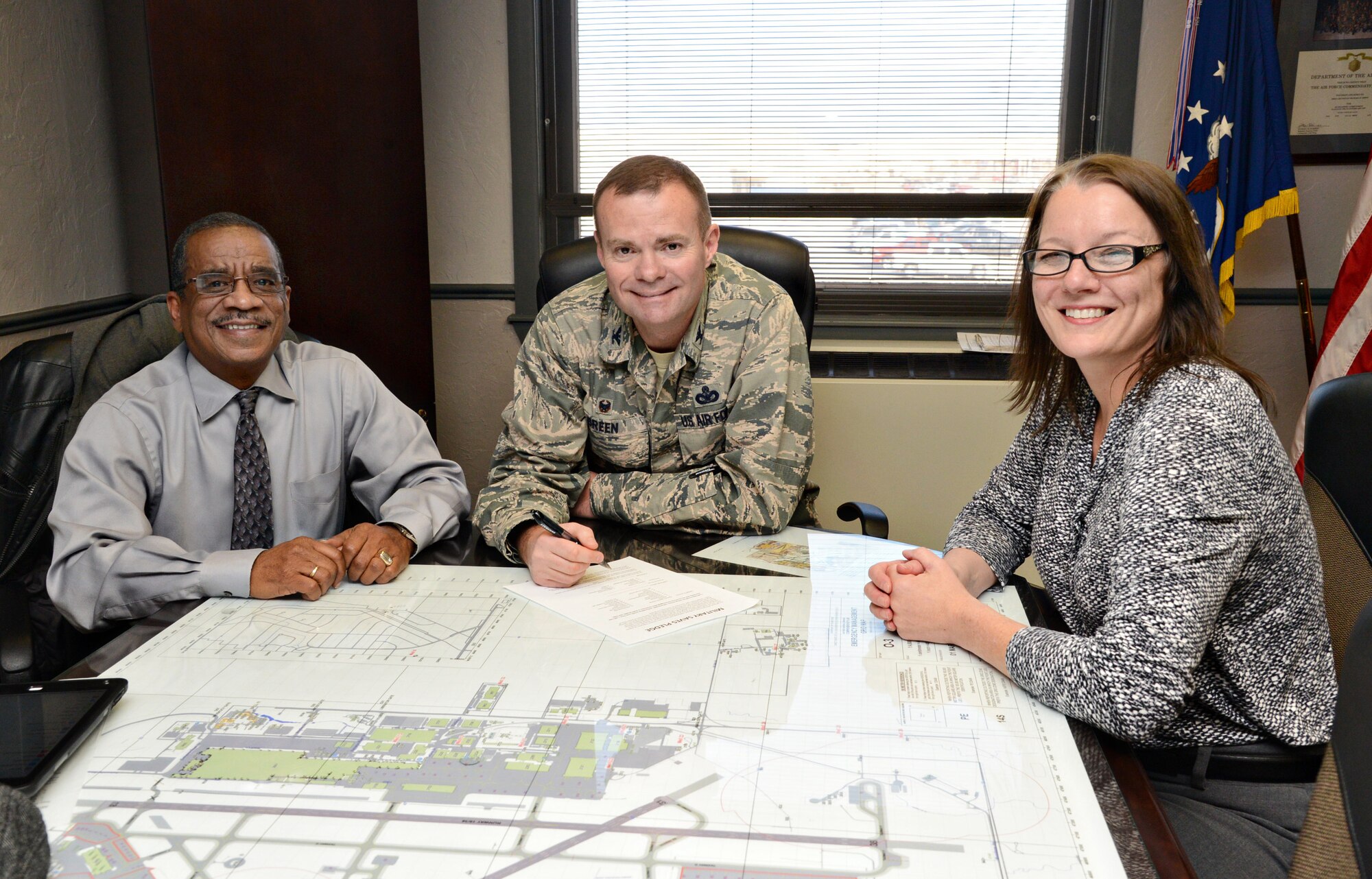 Col. Michael Green, commander of the 72nd Mission Support Group, center, fills out his pledge form for the 2016 Military Saves campaign, which encourages service members, civilians and their families to improve their financial readiness. With Col. Green are, from left, Rickie Smith, the director of the Airman and Family Readiness Center, and Patti Black, the Military Saves representative for Tinker. A financial fair will be held from 10 a.m. to 2 p.m. Feb. 24 at the Tinker Club for anyone who would like further information from financial experts who will be on hand. (Air Force photo by Kelly White/Released)