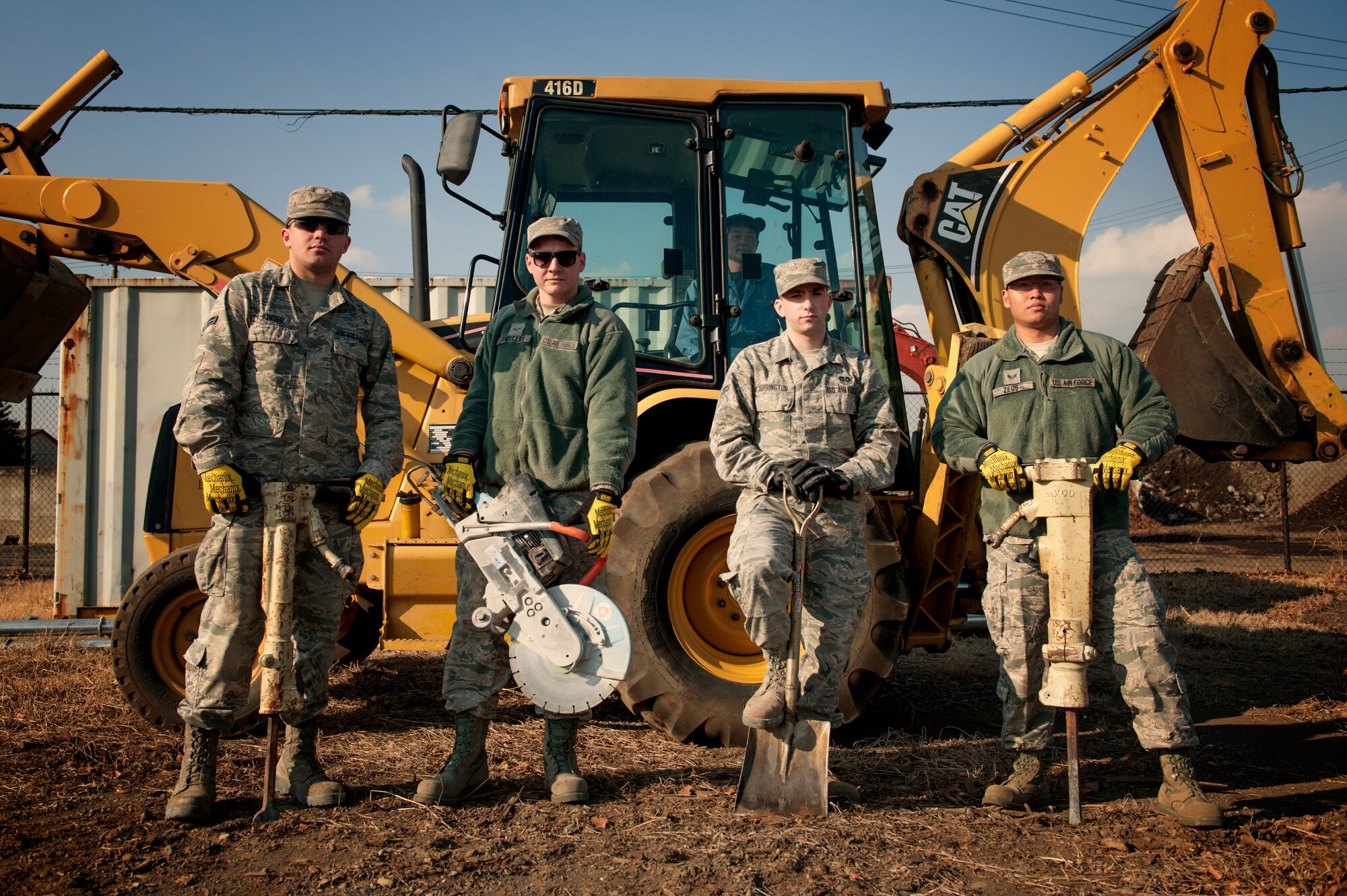 Members of the 374th Civil Engineer Squadron pavement and equipment shop pose for a photo, Jan. 13, 2016, at Yokota Air Base, Japan. From Keeping the flightline mission ready to maintaining the roads and sidewalks, the behind the scenes work done by the group of Airmen known as the ‘Dirt Boys’ keep Yokota’s mission going. (U.S. Air Force photo by Airman 1st Class Delano Scott/Released)
