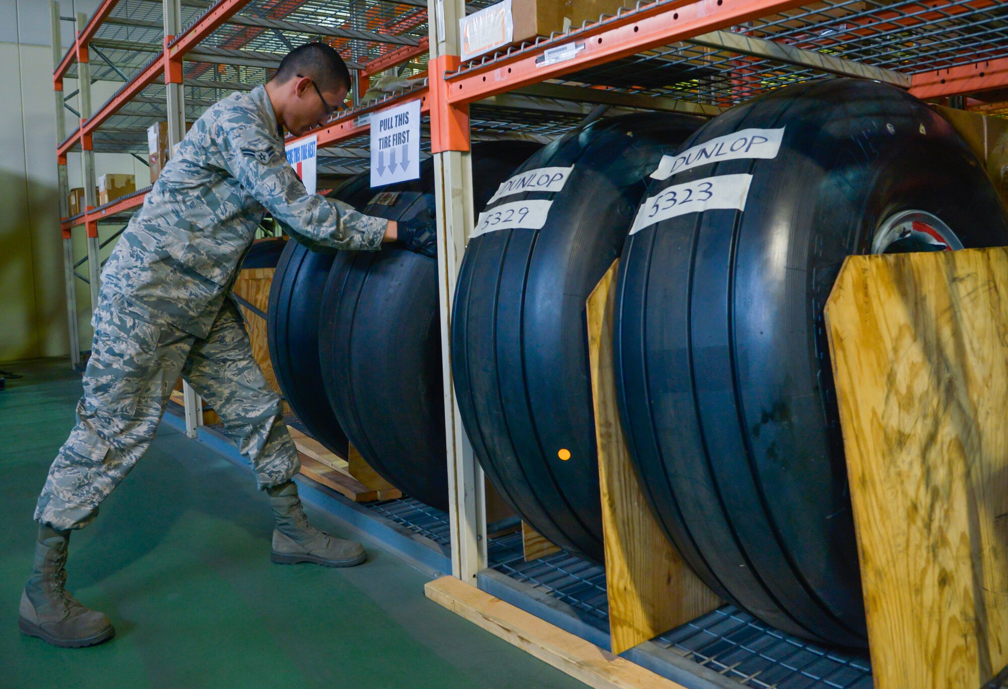 Airman 1st Class Alexander Sharp, 374th Logistics Readiness Squadron materiel management flight aircraft parts store technician, pulls a C-17 Globemaster III tire for an inspection at Yokota Air Base, Japan, Jan. 11, 2016. In addition to providing parts for the C-130 Hercules, the materiel flight supports the Air Mobility Command’s mission in keeping C-5 Galaxy and C-17 Globemaster III aircraft mission capable to move cargo and personnel throughout the Pacific. (U.S. Air Force photo by Senior Airman David Owsianka/Released)