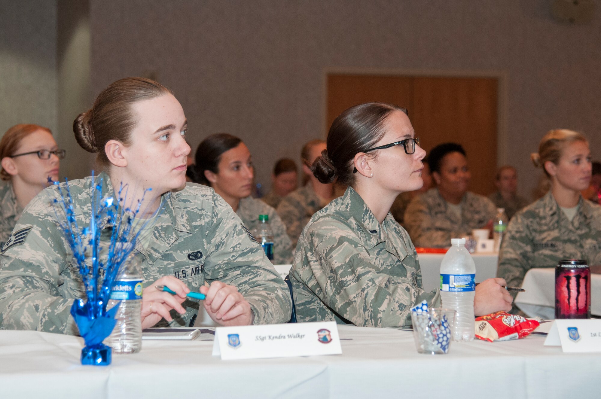 Staff Sgt. Kendra Walker, 90th Missile Security Forces Squadron, and 1st Lt. Kayla Haven, 321st Missile squadron, listen to a speaker at the 20th Air Force Women’s Leadership Symposium on the F.E. Warren Air Force Base, Wyo., Trail’s End Event Center Sept. 16, 2015. Women from across the 20th Air Force came to the ICBM Center for Excellence’s event to discuss leadership issues in the numbered air force. (U.S. Air Force photo by Senior Airman Jason Wiese)