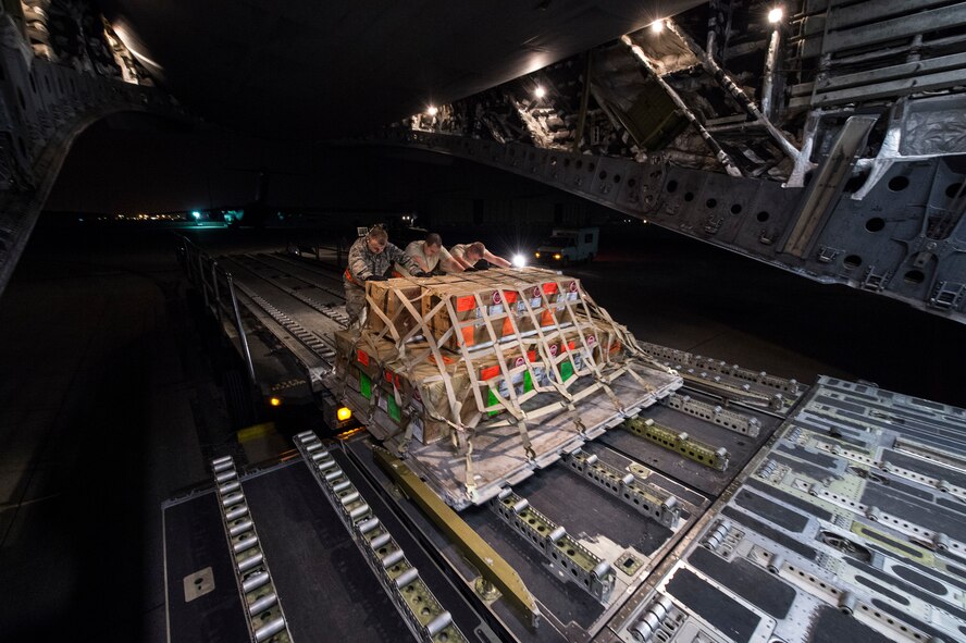 U.S. Air Force Airmen from the 8th Expeditionary Air Mobility Squadron load cargo onto a C-17 Globemaster III at Al Udeid Air Base, Qatar, in support of Operation Resolute Support, Jan. 13, 2016. Operation Resolute Support is the evolution from the International Security Assistance Force (ISAF) combat mission to a Train, Advise and Assist mission of Afghanistan. (U.S. Air Force photo by Staff Sgt. Corey Hook)