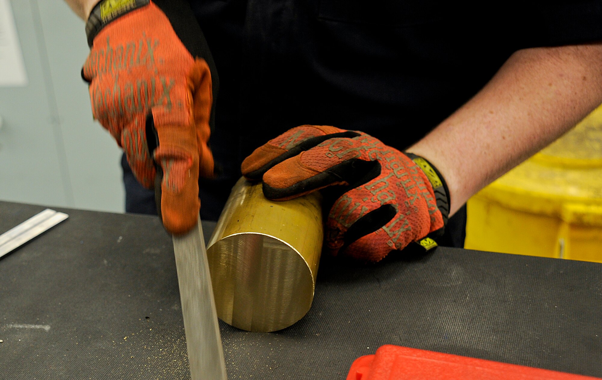 Airman 1st Class Brandon Gentry, an aircraft metals technology technician with the 6th Maintenance Squadron, performs deburring on stock, a large piece of metal, at MacDill Air Force Base, Fla., Jan. 6, 2016. The purpose of deburring stock is so it sits flush on the mounting surface when mounted into the machine. (U.S. Air Force photo by Airman 1st Class Mariette M. Adams)