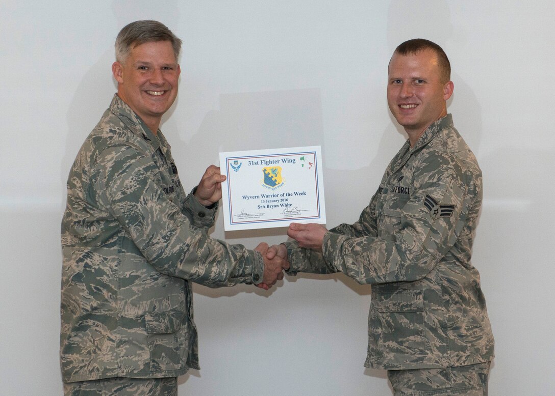 U.S. Air Force Senior Airman Bryan White, 31st Logistics Readiness Squadron Fuels distribution operator, was named the 31st Fighter Wing’s “Wyvern Warrior of the Week,” during a wing staff meeting, Jan. 13, 2016, at Aviano Air Base, Italy. White was recognized by Col. Bryan Wolford, 31st Fighter Wing vice commander, for going above and beyond in his dedication to the mission. (U.S. Air Force photo by Airman 1st Class Cory W. Bush/Released)