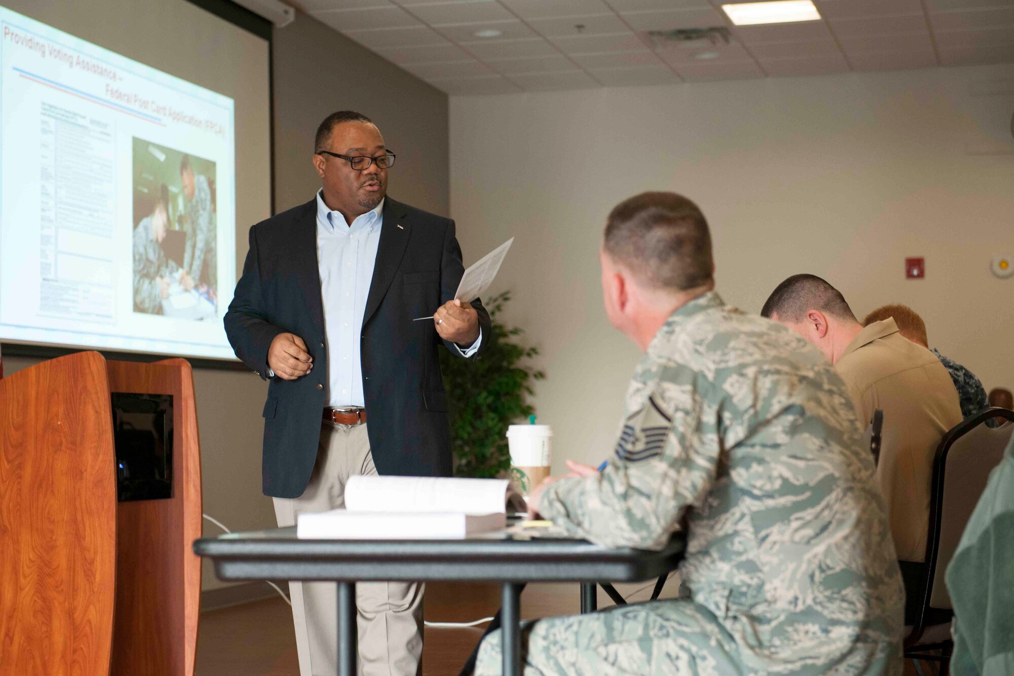 Kenneth Warford, Federal Voting Assistance Program, policy and project compliance deputy director, briefs attendees during a Voting Assistance Workshop at Joint Base Andrews, Md., Jan. 12, 2016. The workshop, run by the Federal Voting Assistance Program, trained more than 50 Department of Defense members on providing assistance to service members and their families during the voting process. (U.S. Air Force photo by Senior Airman Dylan Nuckolls/Released)