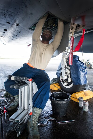 U.S. Air Force Senior Airman Marvin Durè, 67th Aircraft Maintenance Unit F-15 Eagle crew chief, performs maintenance to the underside of an F-15 Eagle Jan. 8, 2016, at Kadena Air Base, Japan. Crew chiefs are responsible for the maintenance of their assigned aircraft to ensure it’s ready to complete missions. (U.S. Air Force photo by Senior Airman Omari Bernard)