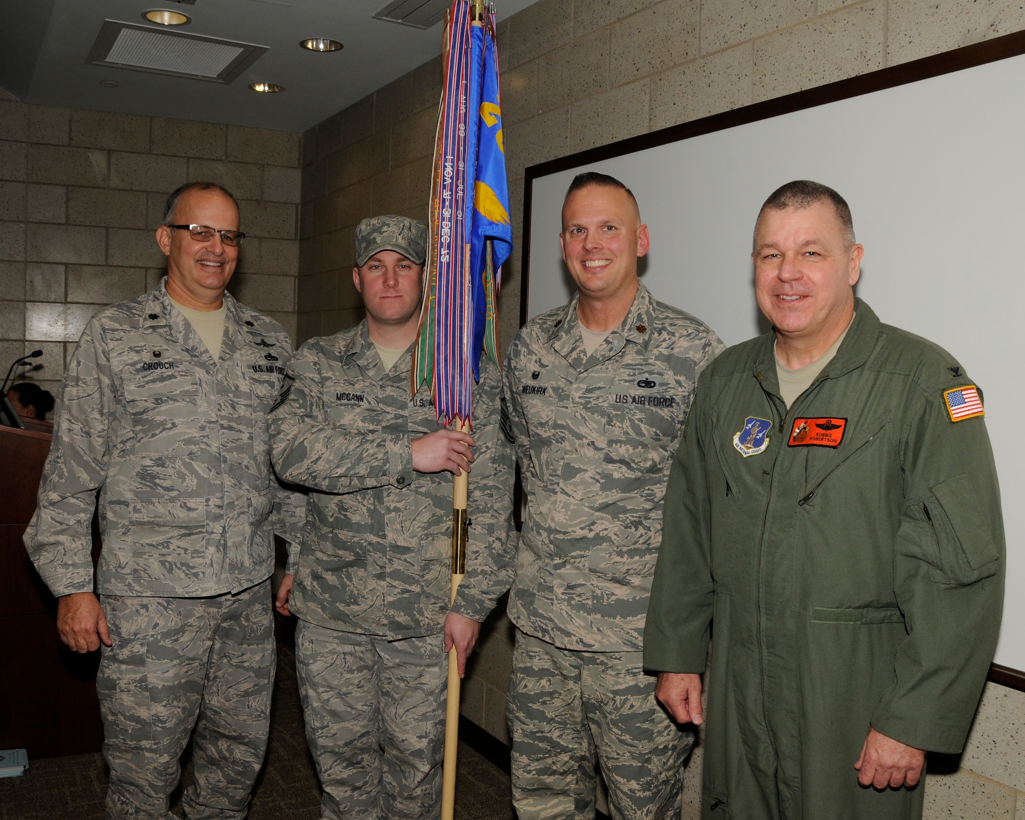 Lt. Col. Ronald Crouch (left), Master Sgt. Eric McCann, Maj. R. Thomas Nieukirk, and Col. William P. Robertson pose after the change of command ceremony for the 264th Combat Communications Squadron Jan. 9, 2016 in Peoria, Ill. Robertson, commander of the 182nd Airlift Wing, presided over the event, where Nieukirk assumed command of the squadron from Crouch. (Air National Guard photo by Tech. Sgt. Todd Pendleton)