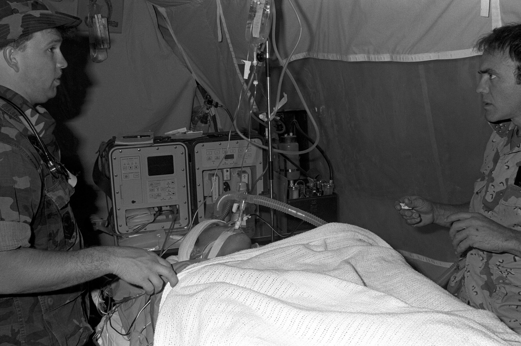 Medical personnel prepare Corporal Richard Ramirez, a member of the 1st Marine Division, for medical evacuation by a C-141B Starlifter aircraft from Al-Jubail Airport to Germany for treatment of chest wounds sustained during Operation DESERT STORM. During this time, Aeromedical Evacuation teams were prepared and were able to transport up to 3,600 casualties a day. (U.S. Air Force photo)
