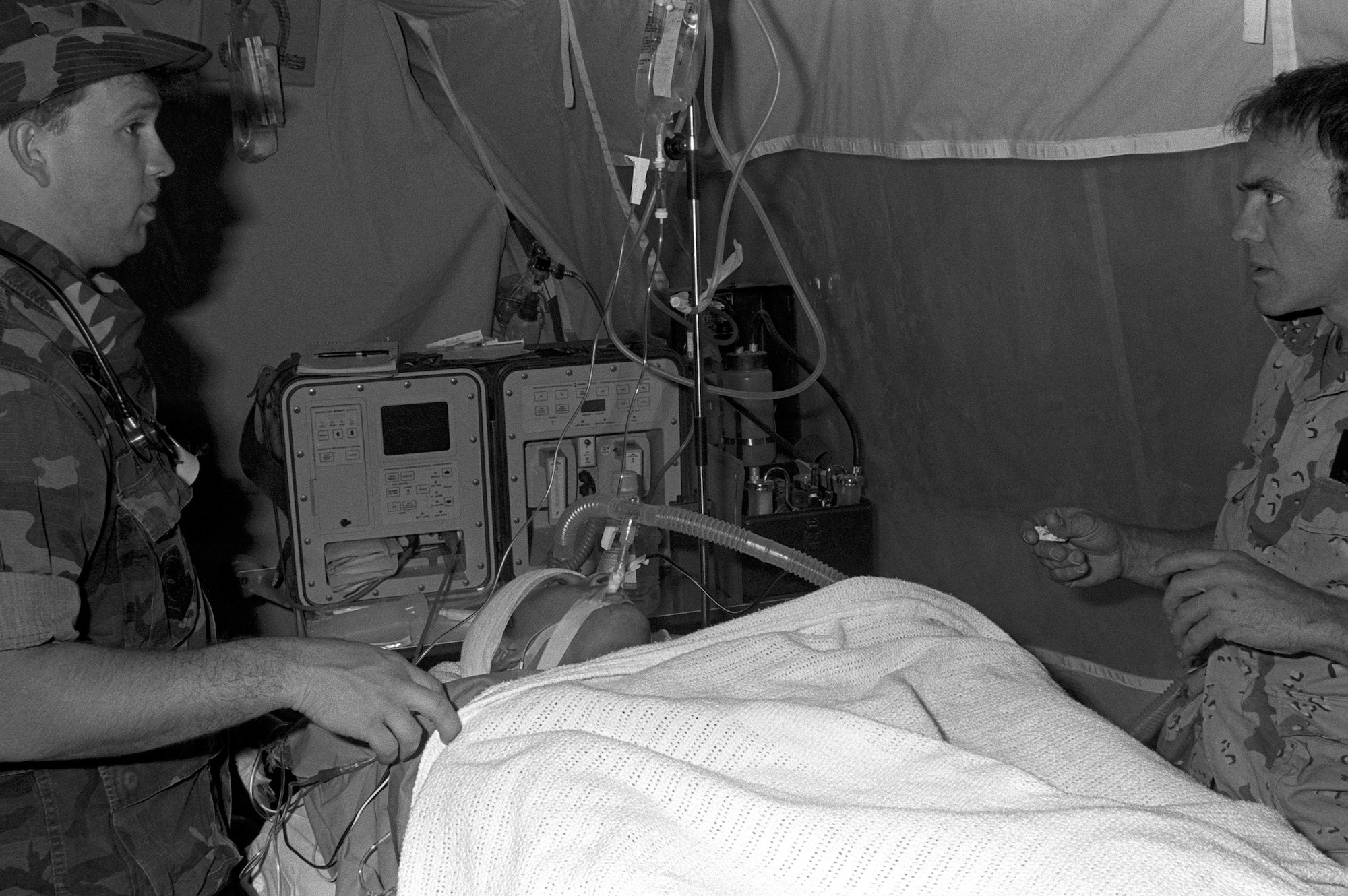 Medical personnel prepare Corporal Richard Ramirez, a member of the 1st Marine Division, for medical evacuation by a C-141B Starlifter aircraft from Al-Jubail Airport to Germany for treatment of chest wounds sustained during Operation Desert Storm. During this time, Aeromedical Evacuation teams were prepared and were able to transport up to 3,600 casualties a day.