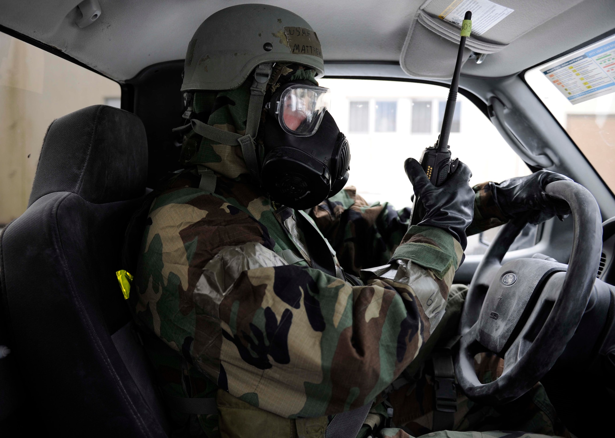 Senior Airman Matthew McDonough, 8th Civil Engineer Squadron emergency management journeyman, radios in to the Unit Control Center after decontaminating the truck. Emergency management specialists at Kunsan Air Base develop plans to ensure Airmen here will keep the mission going. (U.S. Air Force photo by Senior Airman King/Released)