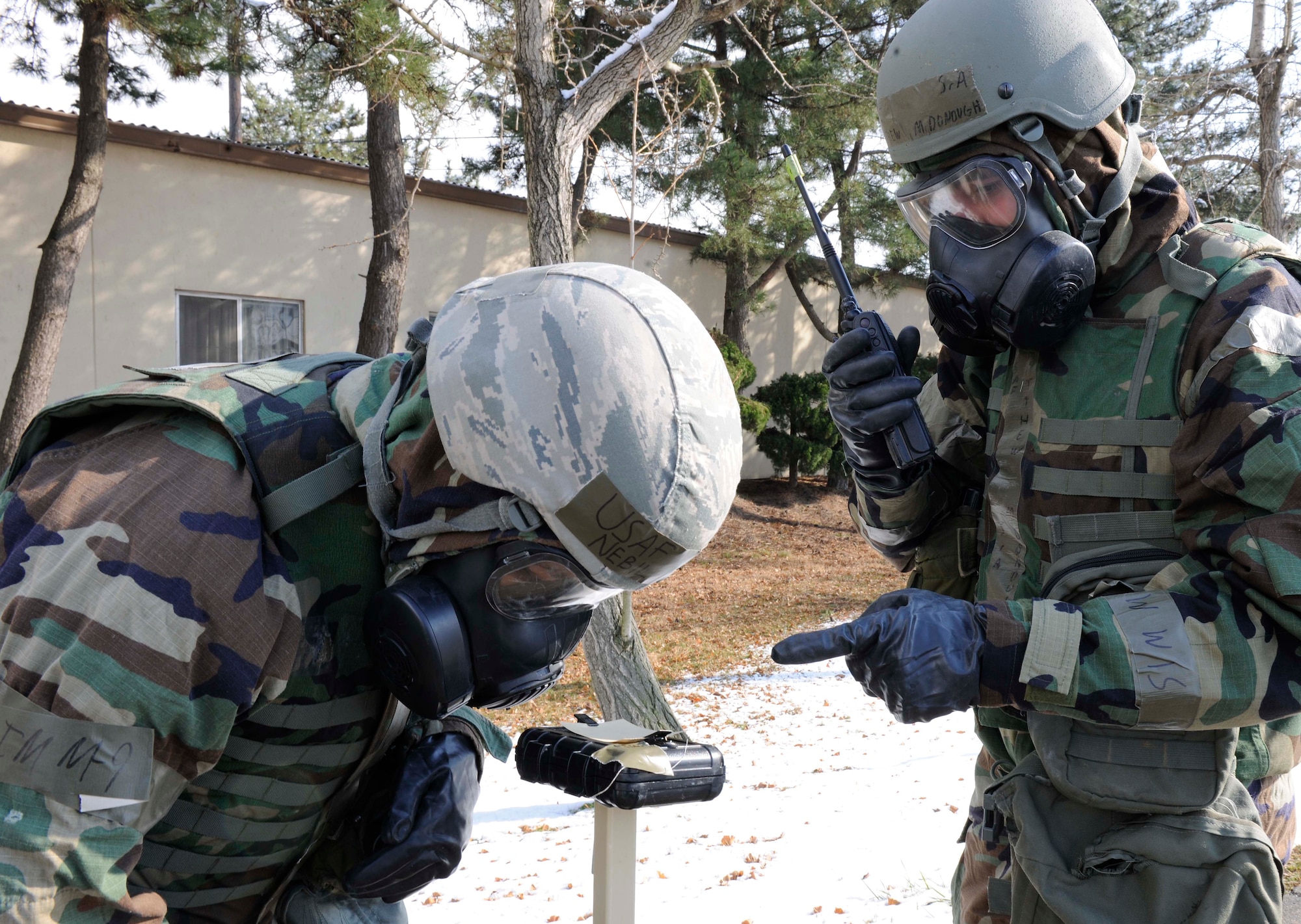 Senior Airmen Matthew McDonough and Nebil Ali, 8th Civil Engineer Squadron emergency management journeymen inspect M8 chemical detection paper for any possible contamination. Emergency management specialists at Kunsan Air Base develop plans to ensure Airmen here will keep the mission going. (U.S. Air Force photo by Senior Airman King/Released)