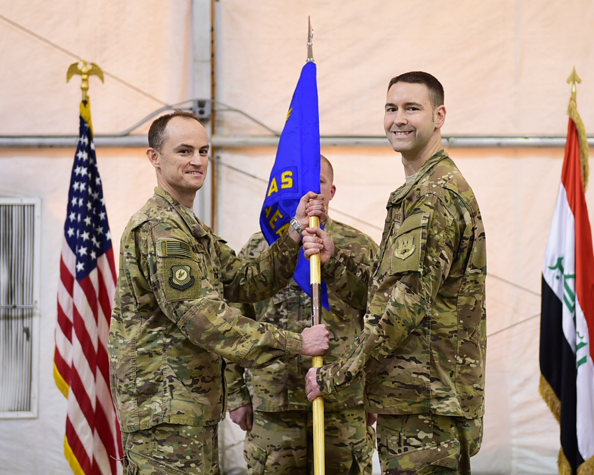 Maj. Ross “Alex” Mol assumes command of the 870th Air Expeditionary Advisory Squadron from Col. Bradley Bridges, 370th Air Expeditionary Advisory Group commander, Jan. 9, 2016 in Baghdad, Iraq. The 870 AEAS provides direct support to the Iraqi Air Force through logistics advise and assist missions, and commands all aerial ports in Iraq.   (U.S. Air Force photo by Staff Sgt. Jerilyn Quintanilla)