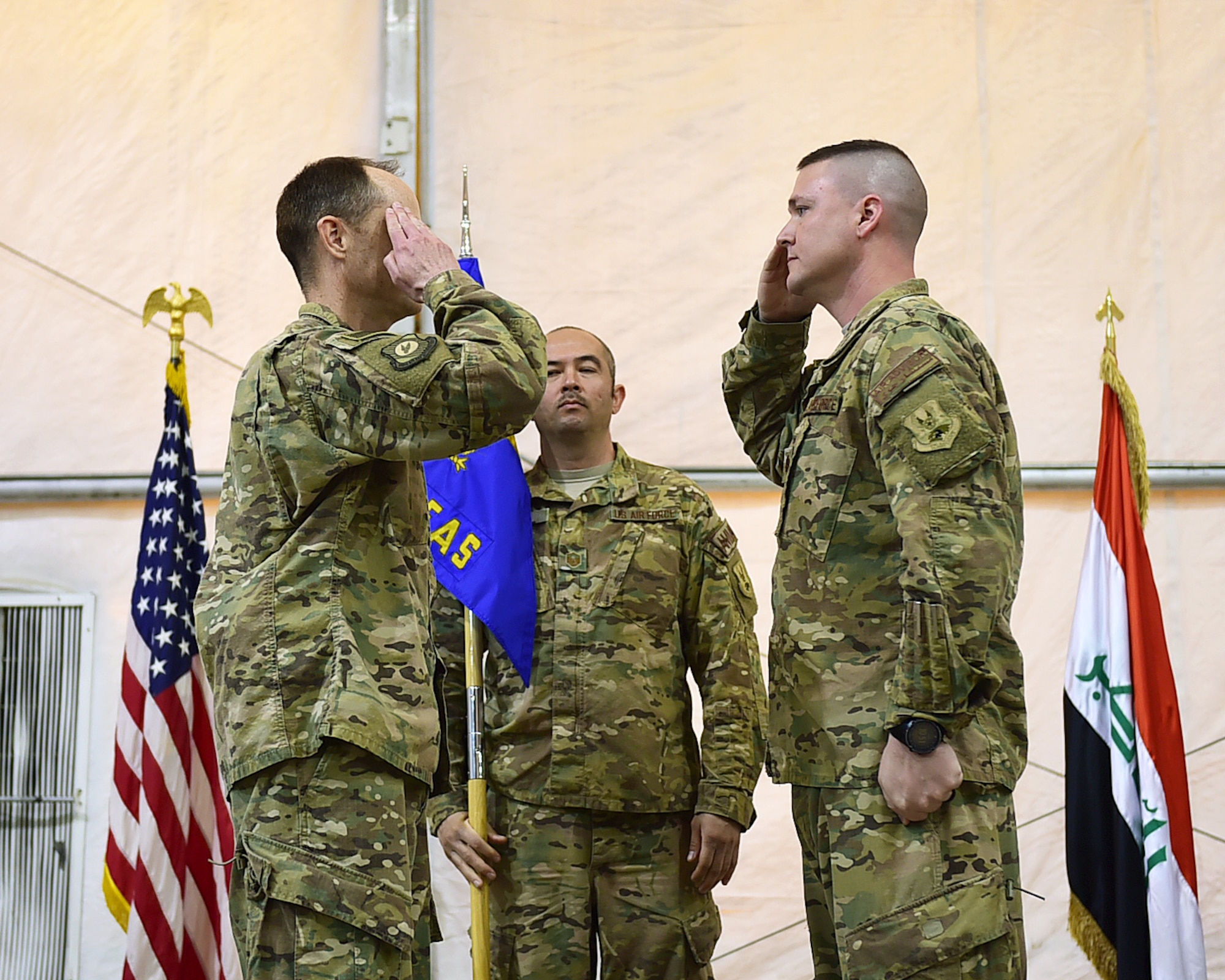 Maj. Eric Quidley, 770th Air Expeditionary Advisory Squadron outgoing commander, renders a salute to Col. Bradley Bridges, 370th Air Expeditionary Advisory Group commander, during a change of command ceremony in Baghdad, Iraq, Jan. 9, 2016. Maj. Todd Meyers, previously assigned to the 911th Maintenance Group, will assume command of the 770th AEAS which provides direct support to the Iraqi Air Force through aircraft maintenance advise and assist missions.  (U.S. Air Force photo by Staff Sgt. Jerilyn Quintanilla)