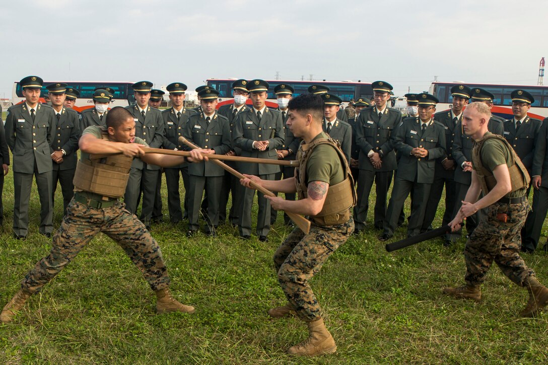 Marines demonstrate how to defend and attack with a rifle for Japan Ground Self-Defense Force officer candidates on Camp Kinser, Okinawa, Japan, Jan. 15. Three hundred and sixty officer candidates visited Combat Logistics Regiment 35 to complete joint and combined operation requirements. The cadets watched Marine Corps Martial Art Program demonstrations, learned the capabilities of various machine guns the Marine Corps uses, and observed a static display of motor transportation vehicles. The Marines are with CLR-35, 3rd Marine Logistics Group, III Marine Expeditionary Force. (U.S. Marine Corps photo by Cpl. Robert Williams Jr./Released)