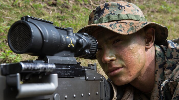 Lance Cpl. Jonathan Gilbert looks through the scope of his M240 medium machine gun while providing security for his platoon Jan. 7, 2016, on Camp Hansen in Okinawa, Japan. Marines with Alpha Company, Battalion Landing Team 1st Battalion, 5th Marines, 31st Marine Expeditionary Unit, navigated the jungles of Okinawa in search of a simulated enemy platoon. Gilbert, a machine gunner with Alpha Co., BLT 1/5, 31st MEU, is a native of Frederick, Maryland. 