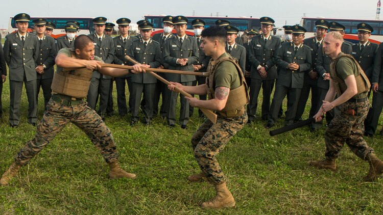 Marines demonstrate how to defend and attack with a rifle for Japan Ground Self-Defense Force officer candidates on Camp Kinser, Okinawa, Japan, Jan. 15,2016. Three hundred and sixty officer candidates visited Combat Logistics Regiment 35 to complete joint and combined operation requirements. The cadets watched Marine Corps Martial Art Program demonstrations, learned the capabilities of various machine guns the Marine Corps uses, and observed a static display of motor transportation vehicles. The Marines are with CLR-35, 3rd Marine Logistics Group, III Marine Expeditionary Force. 