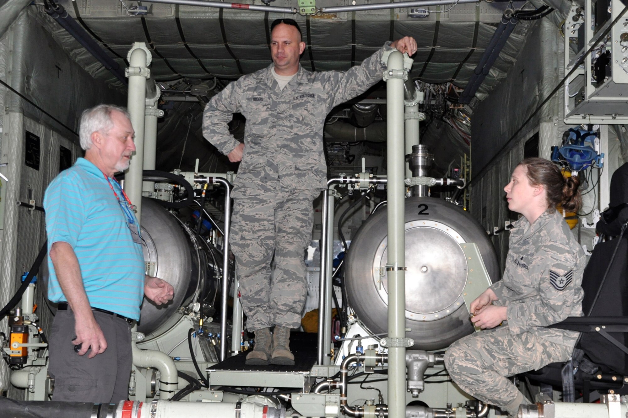Tech. Sgt. Jeremy Rogers (center) and Tech. Sgt. Jess Strumbly, both aerial spray maintainers assigned to the 910th Airlift Wing’s aerial spray maintenance flight, talk with a participant of the Department of Defense Aerial Spray Certification Course on the cargo deck of one of the 910th’s specially-modified, aerial spray capable C-130 aircraft on the flightline at Page Field here, Jan. 12, 2016. The static display of the aircraft and aerial spray equipment was part of the four-day course, which is a certification requirement for pest management specialists involved in the aerial spraying of products designed to destroy disease-carrying creatures. (U.S. Air Force photo/Master Sgt. Bob Barko Jr.)