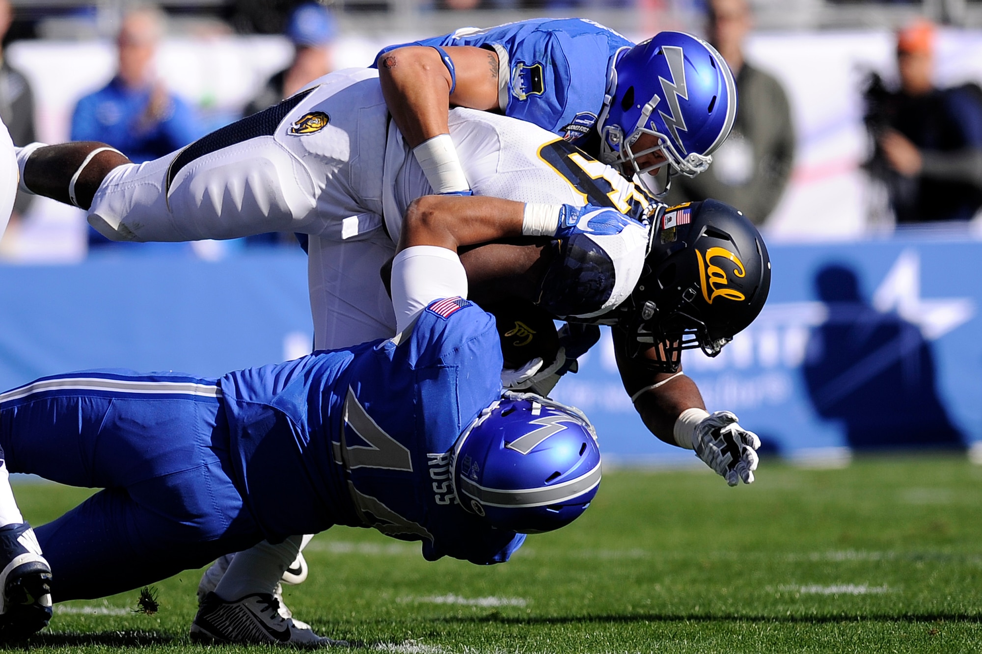 U.S. Air Force Academy defensive back Brodie Hicks, a junior, and linebacker Grant Ross, a sophomore, tackle a Cal player as the Air Force Academy Falcons met the Golden Bears of California in the Armed Forces Bowl in Fort Worth, Texas, Dec. 29, 2015. The Falcons fell to the Golden Bears 55-36. Air Force finished the season with an 8-6 overall record. (U.S. Air Force photo/ Mike Kaplan)
