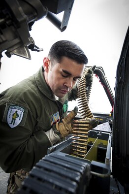 Tech. Sgt. Joshua Peters, a 41st Rescue Squadron special missions aviator, loads ammunition into an HH-60G Pave Hawk Jan. 7, 2016, at Moody Air Force Base, Ga. The Pave Hawk features two crew-served .50-caliber machine guns, one located on each side. Peters was loading the weapons as part of a training mission. (U.S. Air Force photo/Airman 1st Class Lauren M. Johnson)