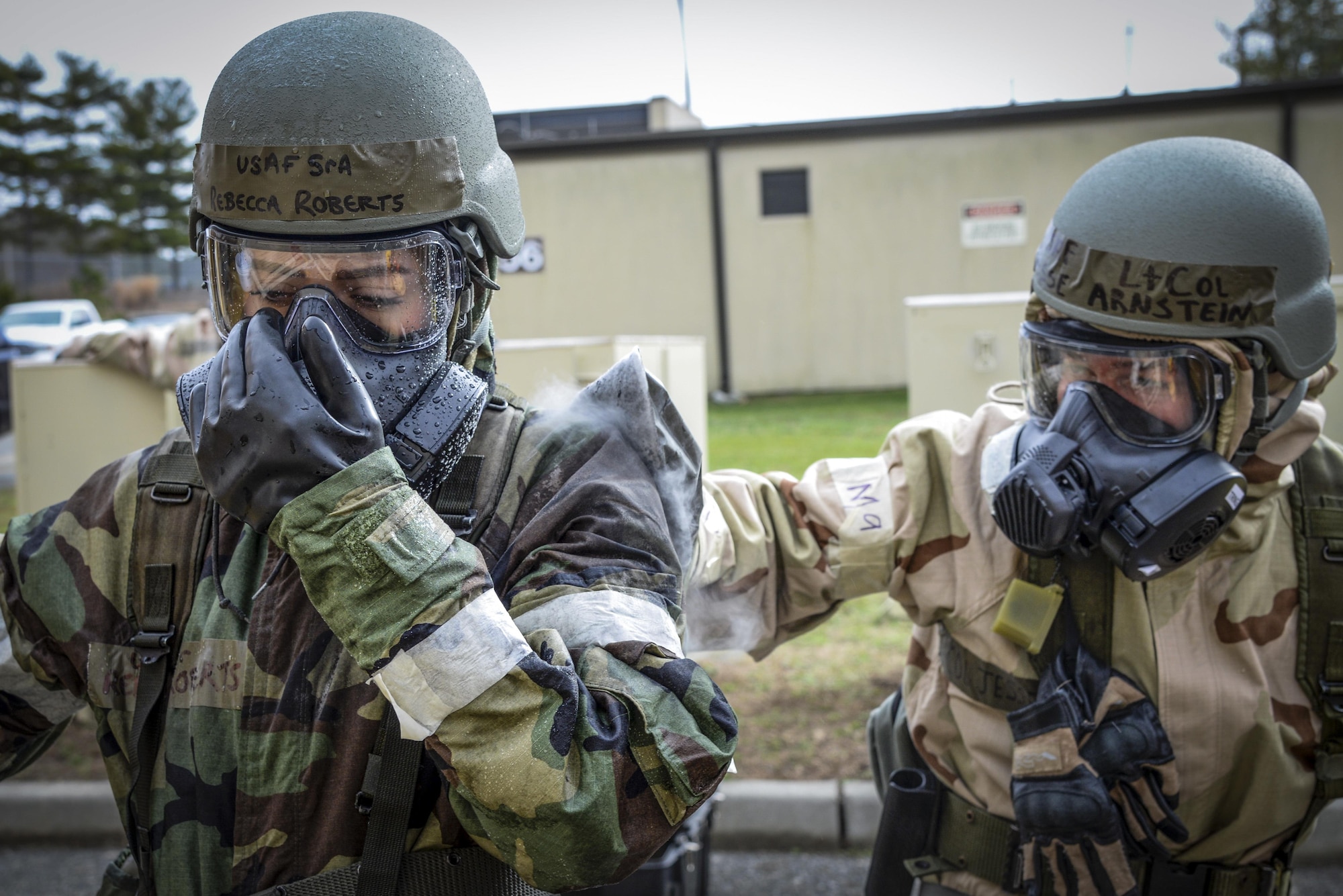 Lt. Col. Jesse Arnstein, right, helps decontaminate Senior Airman Rebecca Roberts in a simulated exercise Jan. 9, 2016, at Atlantic City Air National Guard Base, N.J. The simulated decontamination was part of the 177th Fighter Wing's participation in contamination control area training. (U.S. Air National Guard photo/Senior Airman Shane Karp)