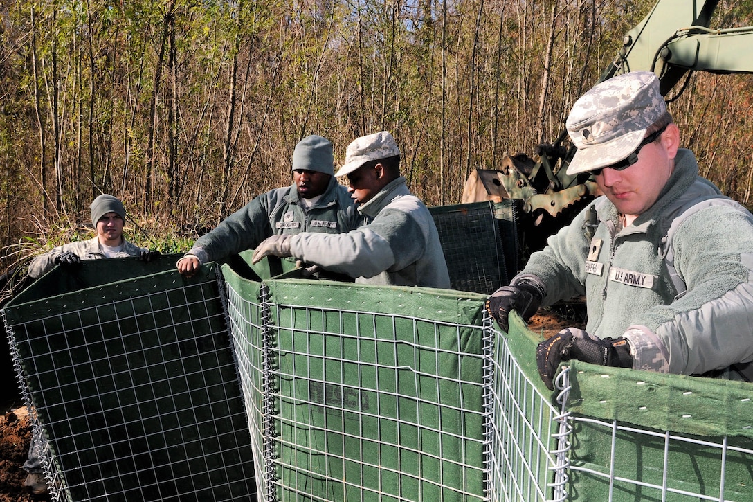 Soldiers erect barriers to build a levee to support Operation Winter River Flooding in Krotz Springs, La. Jan. 10, 2016. The soldiers are assigned to the Louisiana Army National Guard’s 256th Infantry Brigade Combat Team. Louisiana National Guard photo by Army Staff Sgt. Greg Stevens