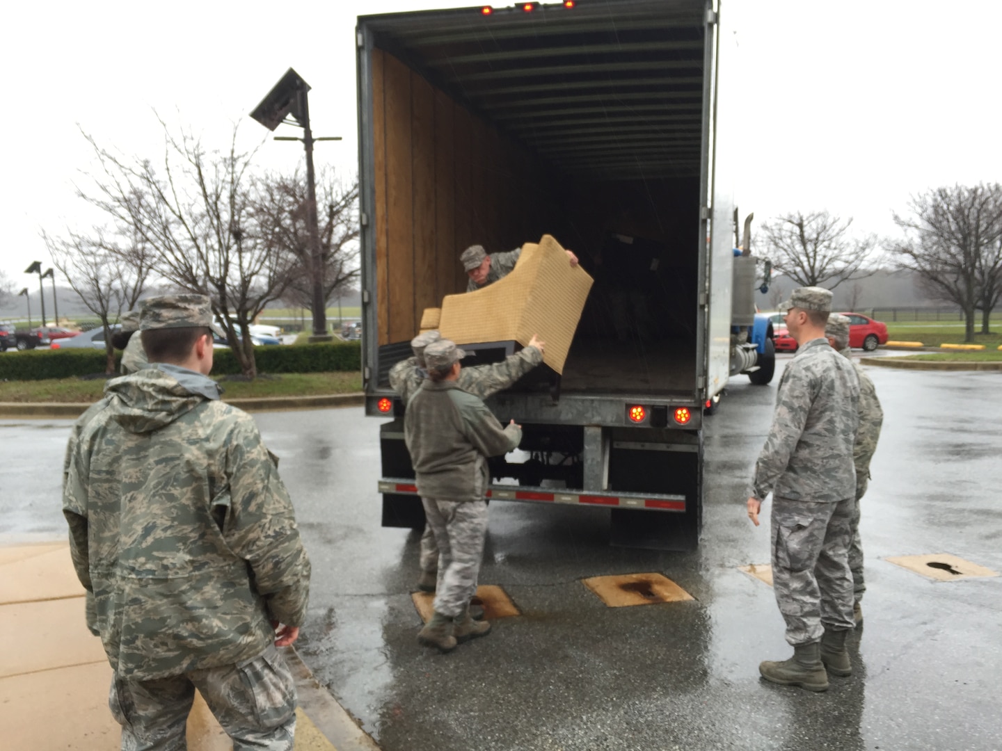 Tech. Sgt. Jared Whitecar, Air Force Mortuary Affairs Operations broadcaster, unloads a chair Dec. 23, 2015, at New Castle Air National Guard Base, Delaware. The furniture was relocated from Dover Air Force Base to create an area for families of the fallen when a dignified transfer was diverted due to weather. 