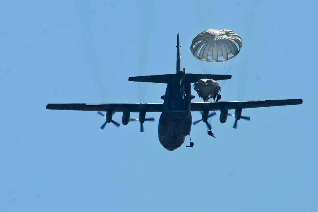 U.S. soldiers exit a C-130H Hercules aircraft during a static-line training jump over Soto Cano Air Base in Honduras, Jan. 11, 2016. The soldiers are assigned to Special Operations Command South, and the aircraft crew is assigned to the Wyoming Air National Guard’s 153rd Airlift Wing. The jump served as an opportunity for U.S. and Honduran soldiers to maintain interoperability for future airborne operations. U.S. Air Force photo by Capt. Christopher Mesnard