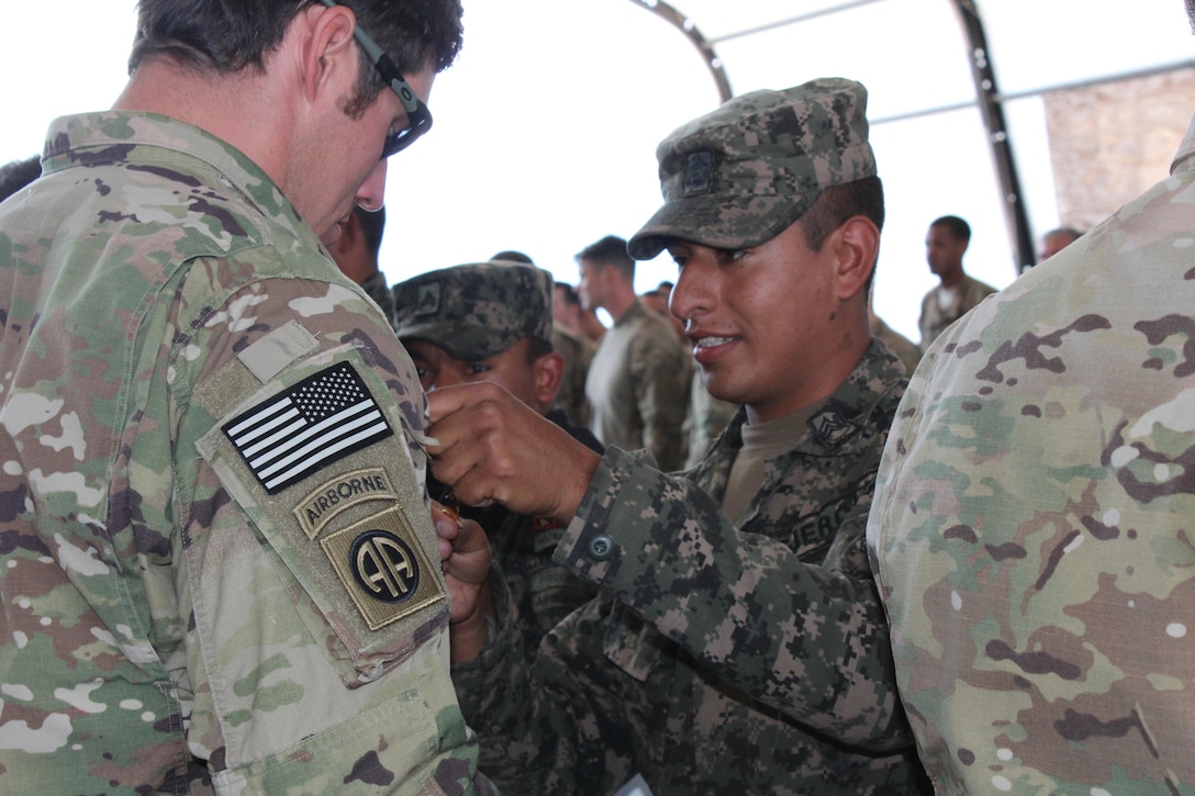 Honduran and U.S. soldiers exchange airborne jump wings after a static-line training exercise on Soto Cano Air Base in Honduras, Jan. 11, 2016. U.S. Army photo by Maria Pinel