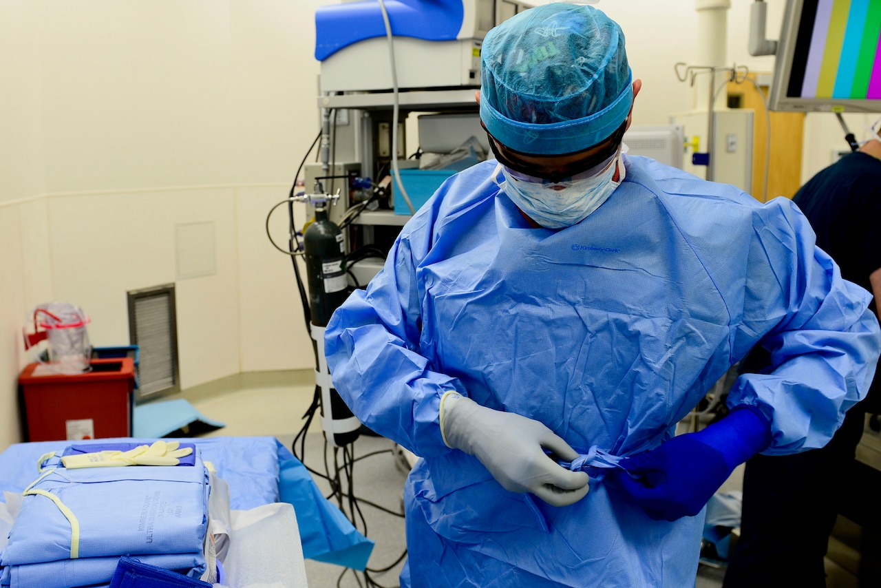 Air Force Airman 1st Class Gustavo Lombana, 633rd Medical Group surgical technician, prepares to assist in an operation on Langley Air Force Base, Va., Oct. 27, 2015. Air Force photo by Airman 1st Class Derek Seifert